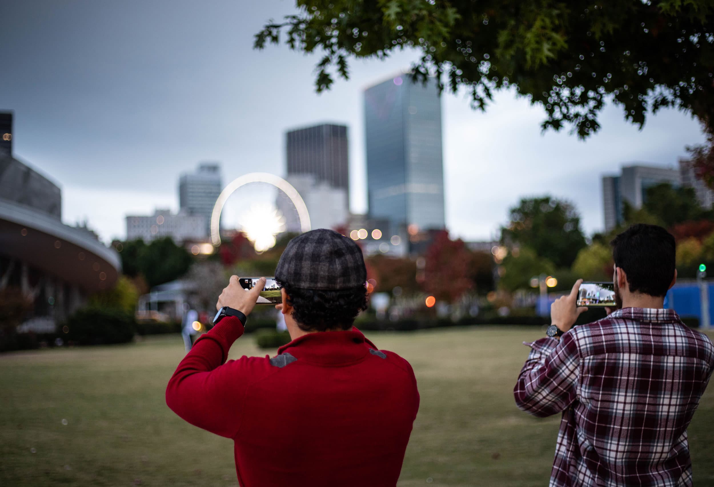 The skyline of Atlanta’s Downtown in soft focus with a ferris wheel in the distance.