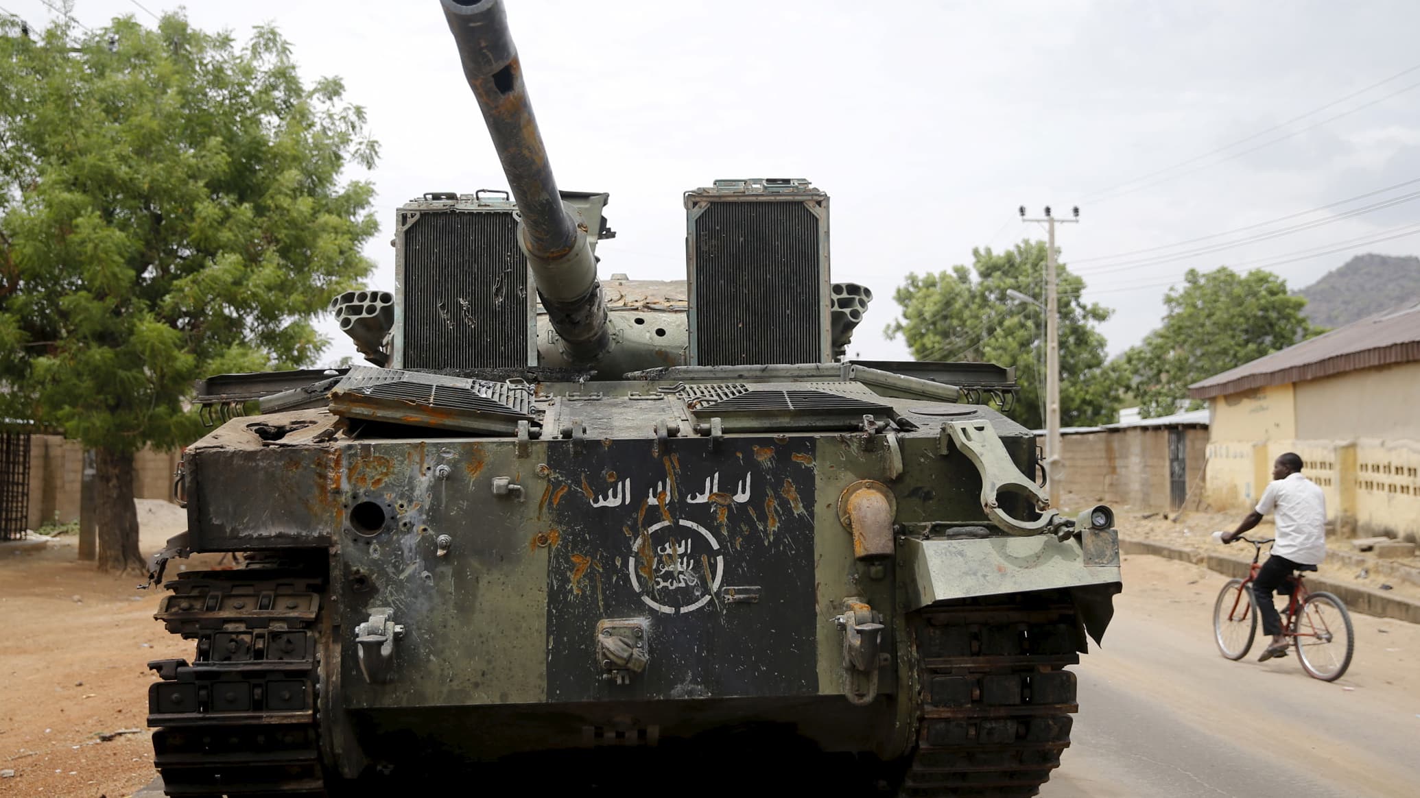 Large green tank with Arabic script logo.