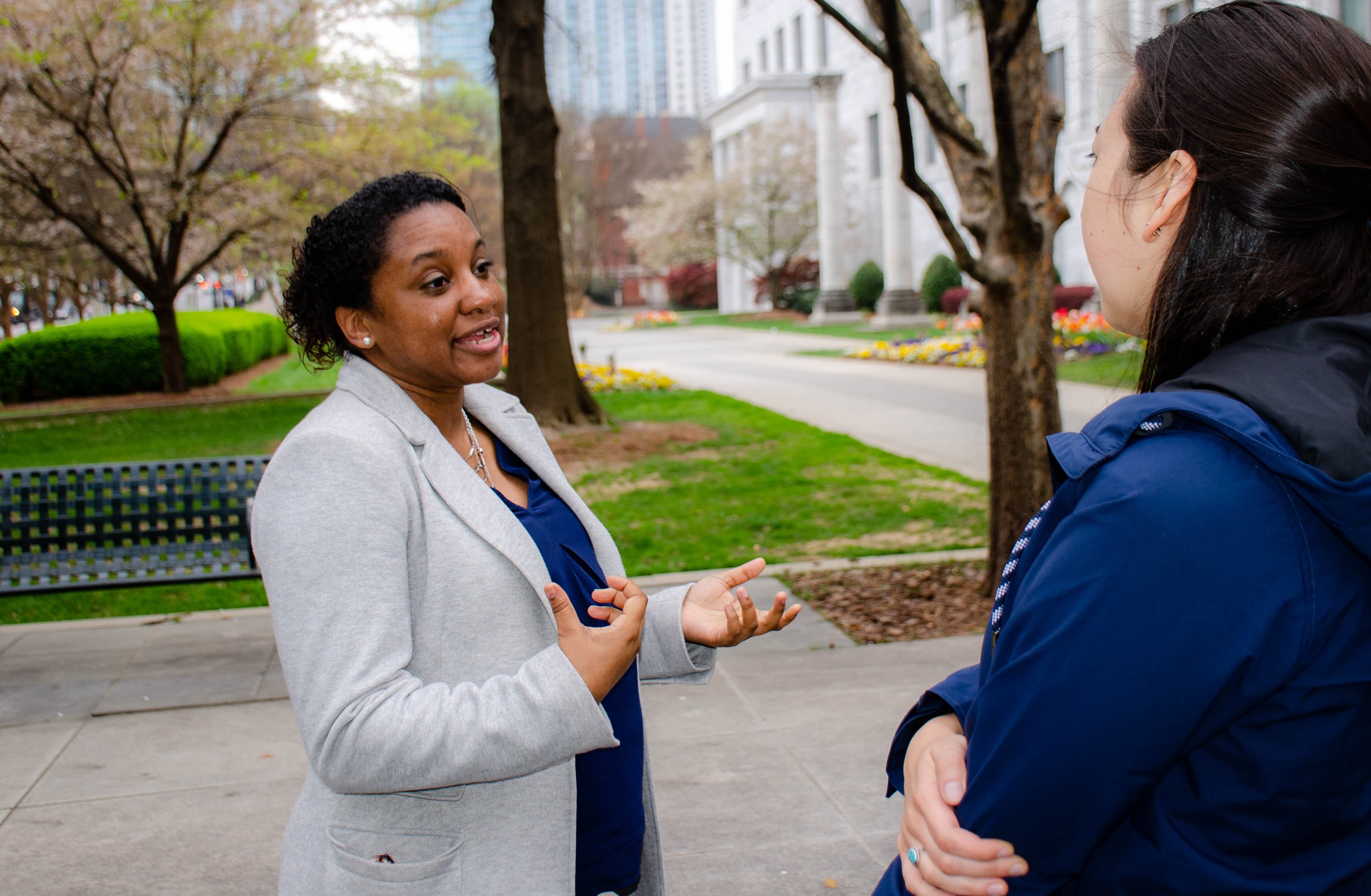 A woman stands in a park.