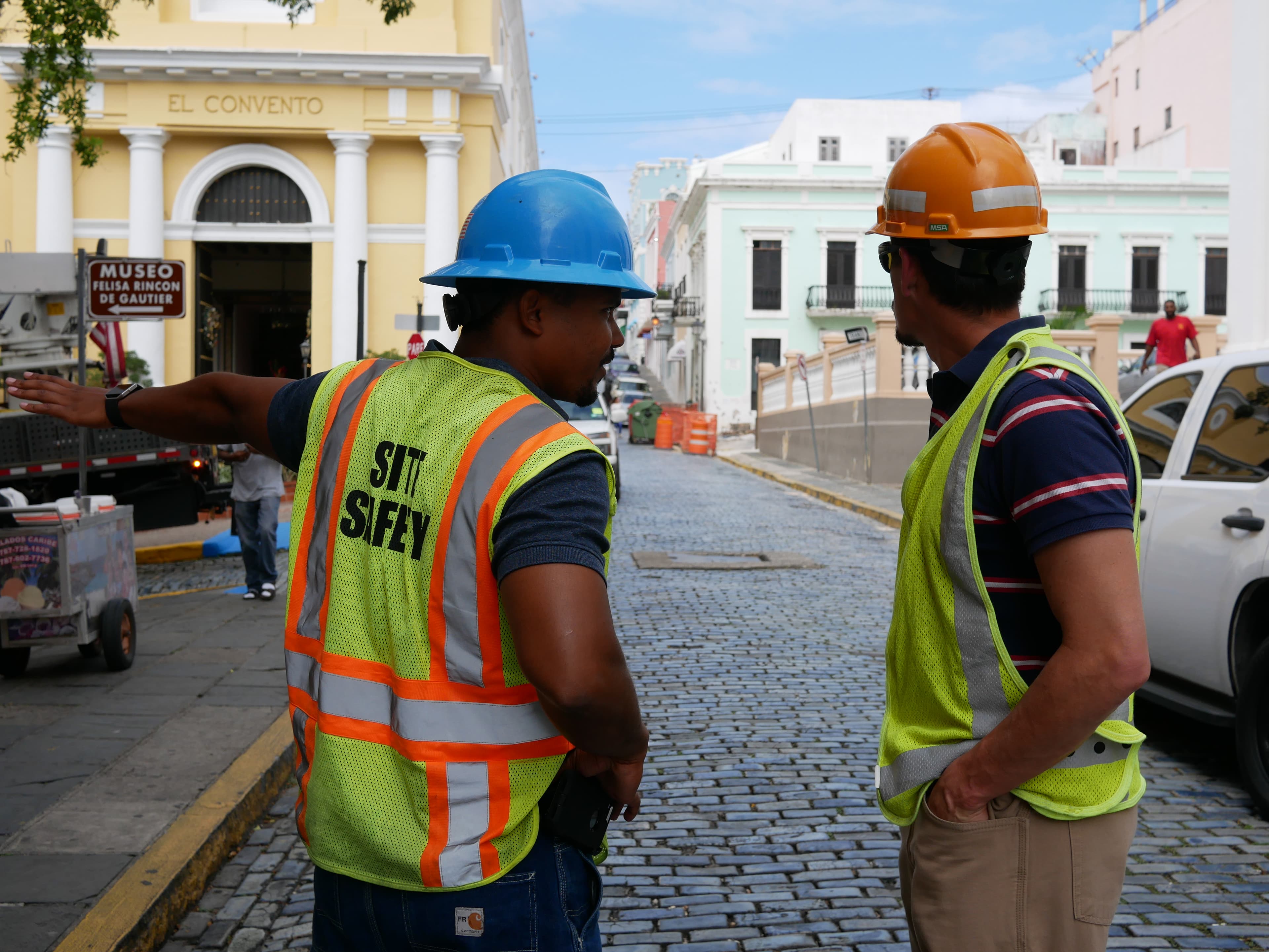 Con Edison crew supervisor Richard Gonzalez (l) and electrical engineer Aaron Anaya (r) speak at a work site in Old San Juan.