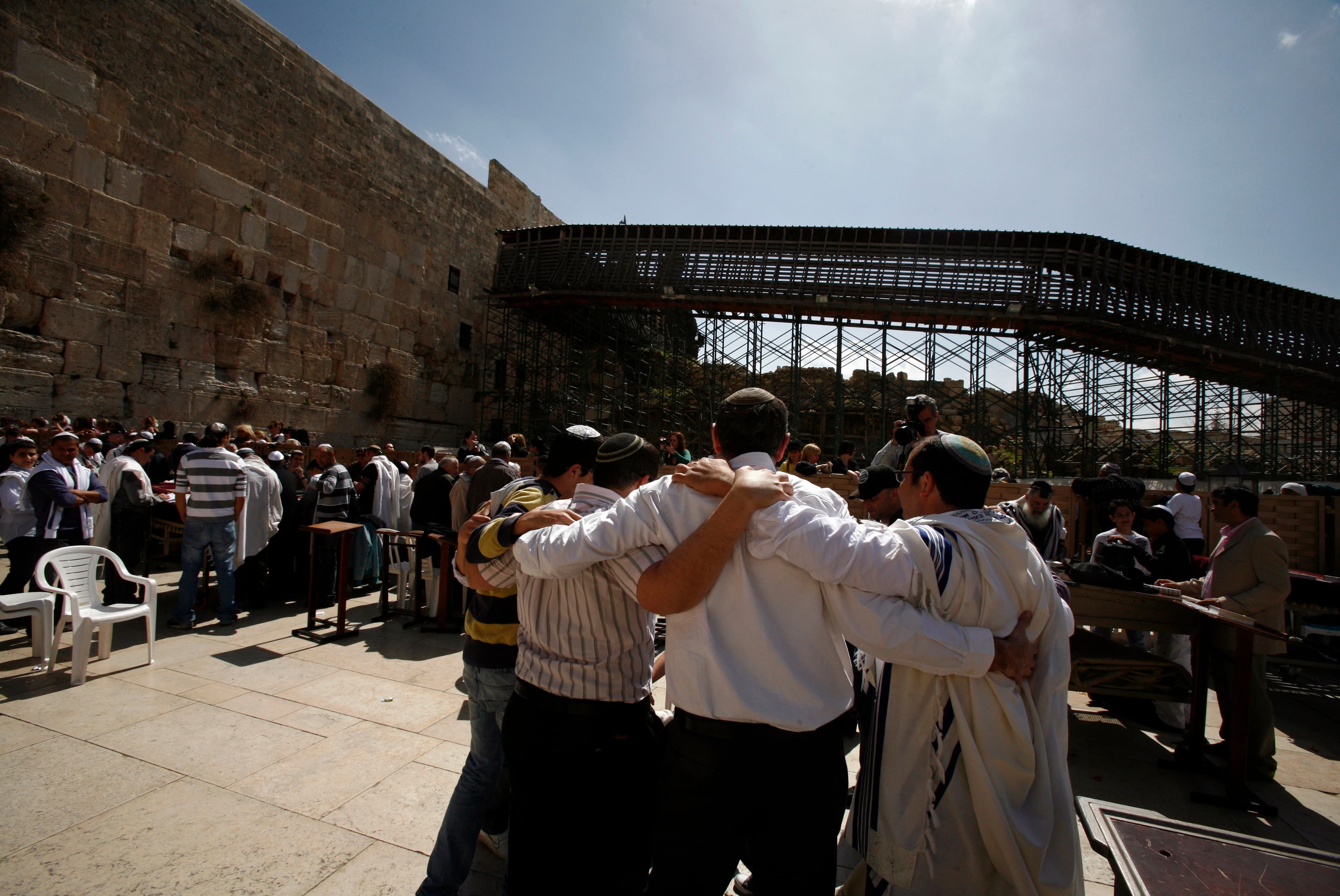 A group of men huddle and dance outside Jerusalem's Western Wall.