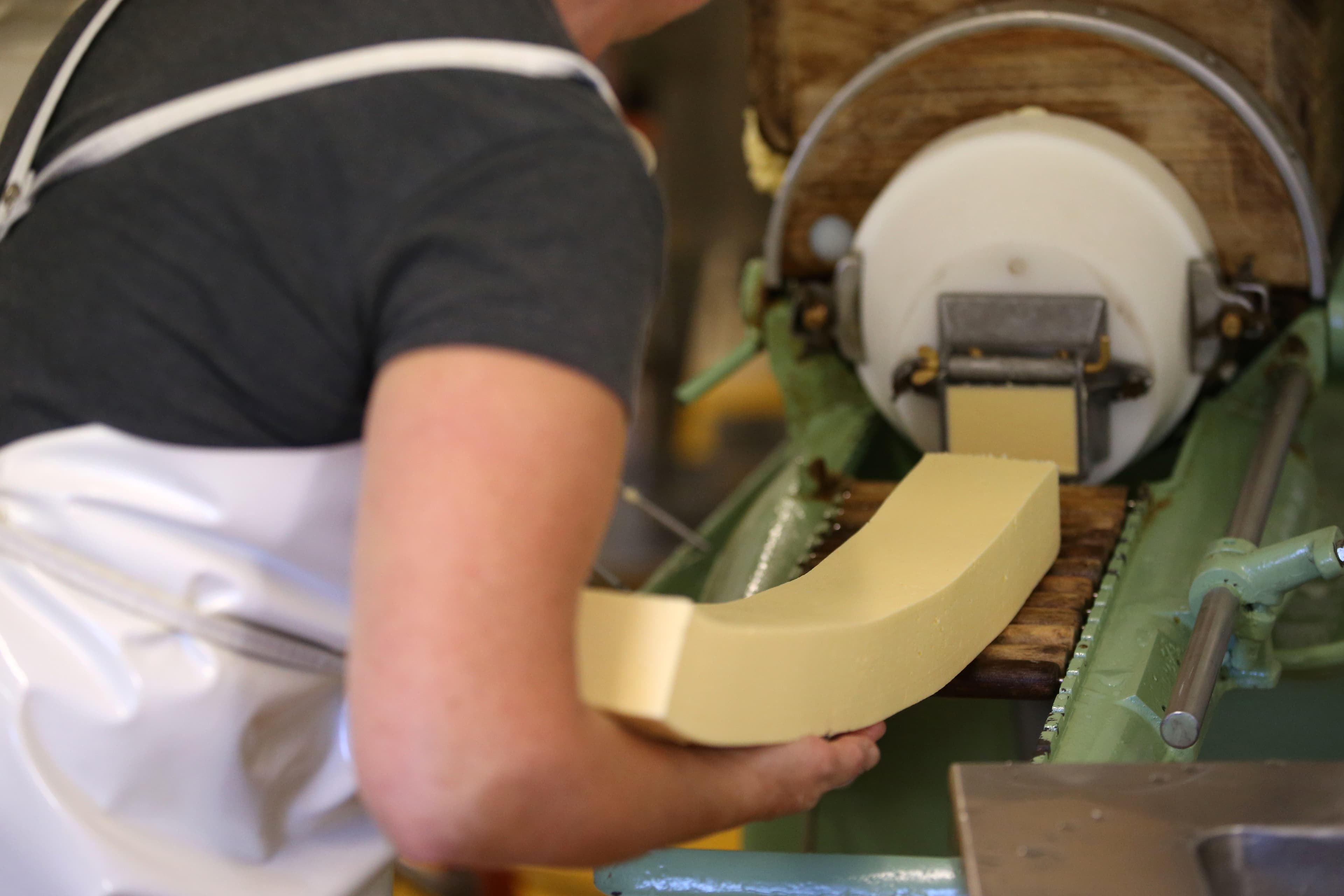 An employee prepares organic unpasteurized butter