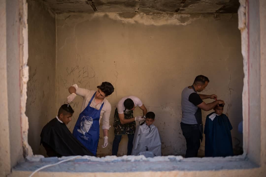 Young volunteers give free haircuts to survivors of floods in Khuzestan province in Western Iran.