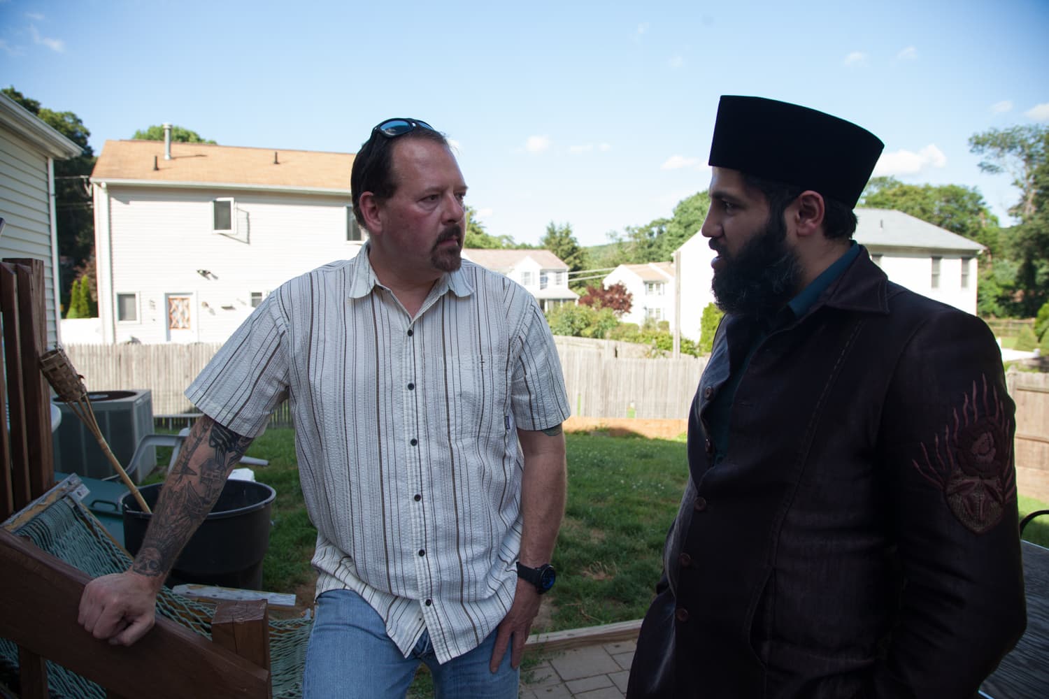 Two men standing outdoors talking