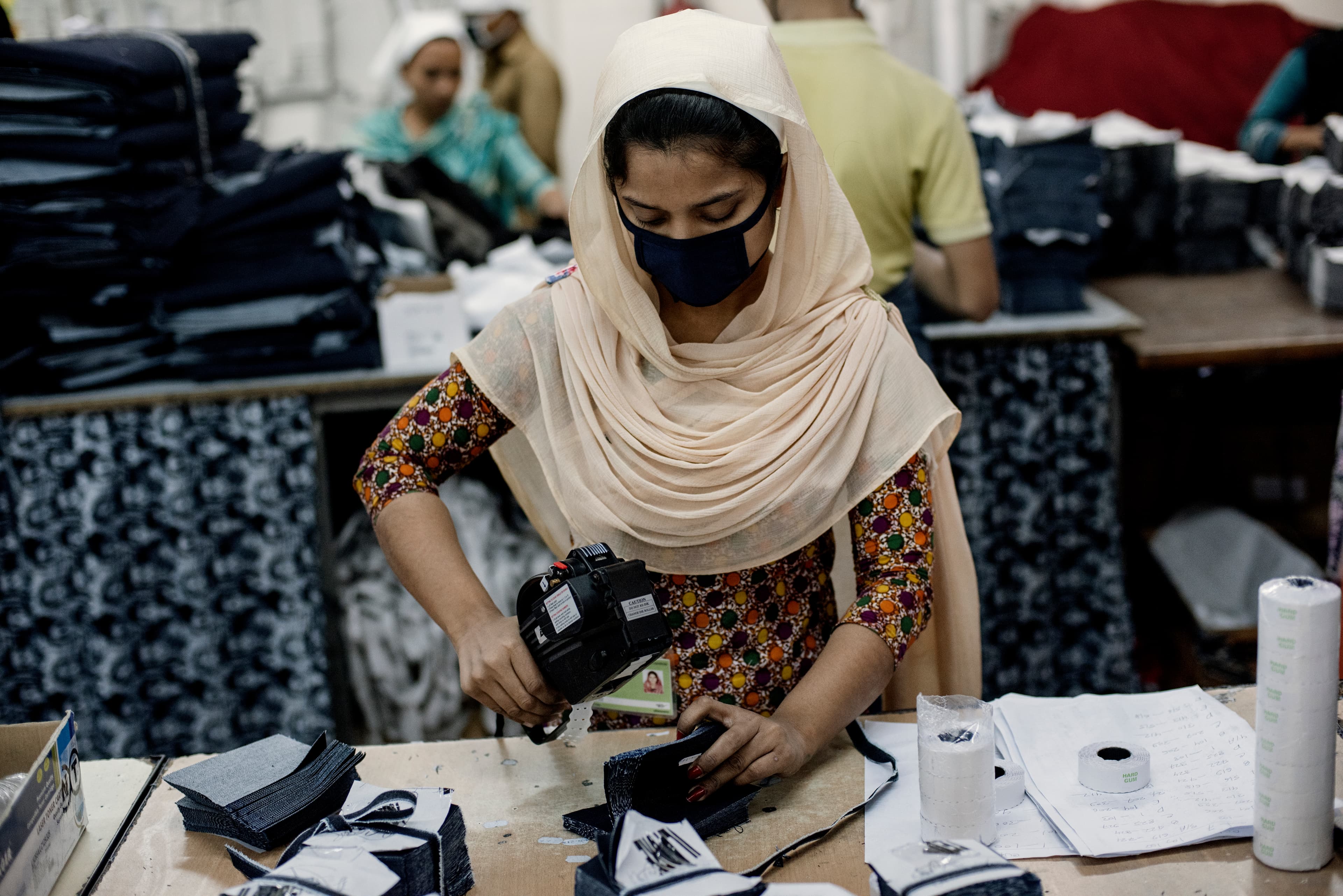 Garment factory worker making denim jeans.