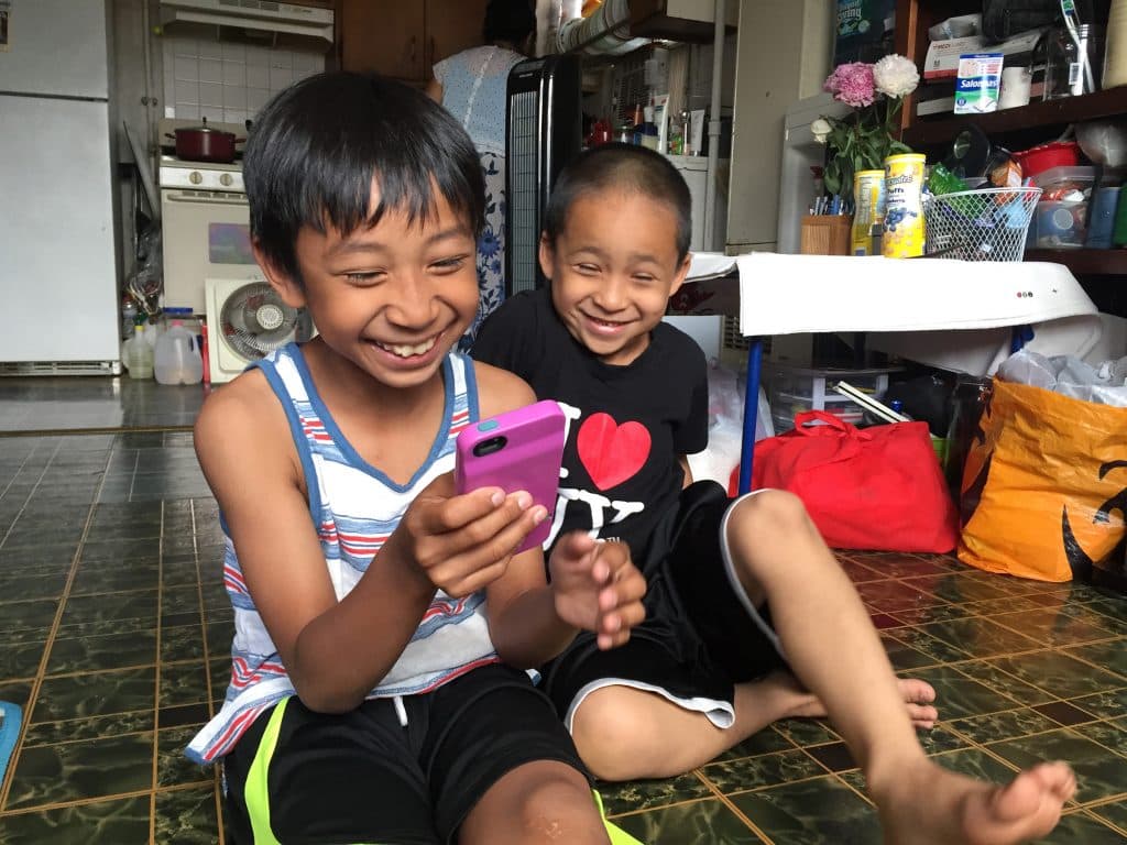 Nine-year-old Maddox uses an app to help translate the words he doesn’t know in Khmer when he accompanies his grandmother to her doctor’s visits, where she’s treated for symptoms of PTSD.