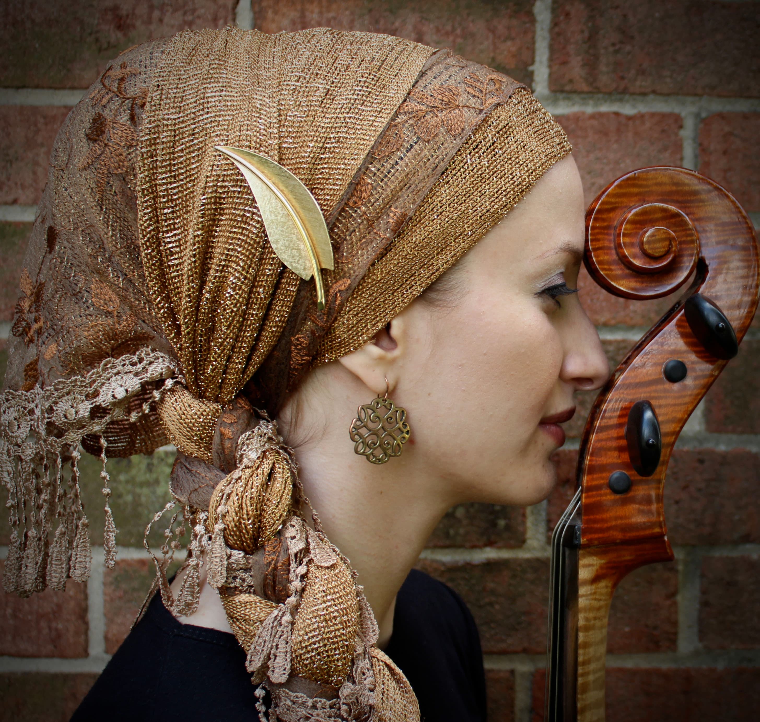 A woman with a head covering is looking right