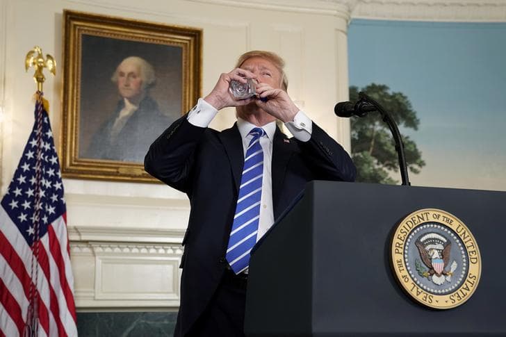 U.S. President Donald Trump takes a drink of water as he speaks about his recent trip to Asia in the Diplomatic Room of the White House in Washington, U.S., November 15, 2017.
