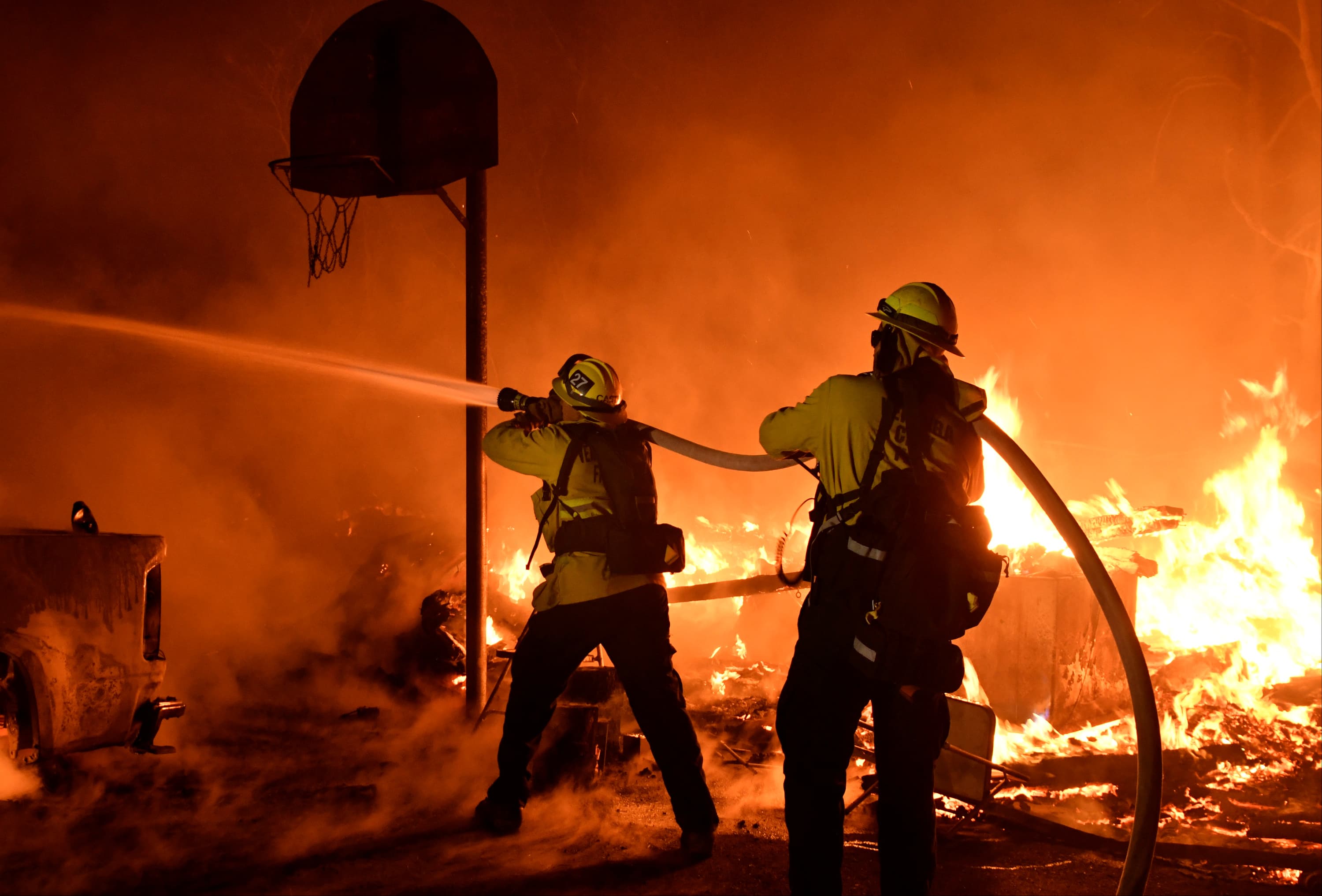 Firefighters battle flames from a Santa Ana wind-driven brush fire called the Thomas Fire in Santa Paula.