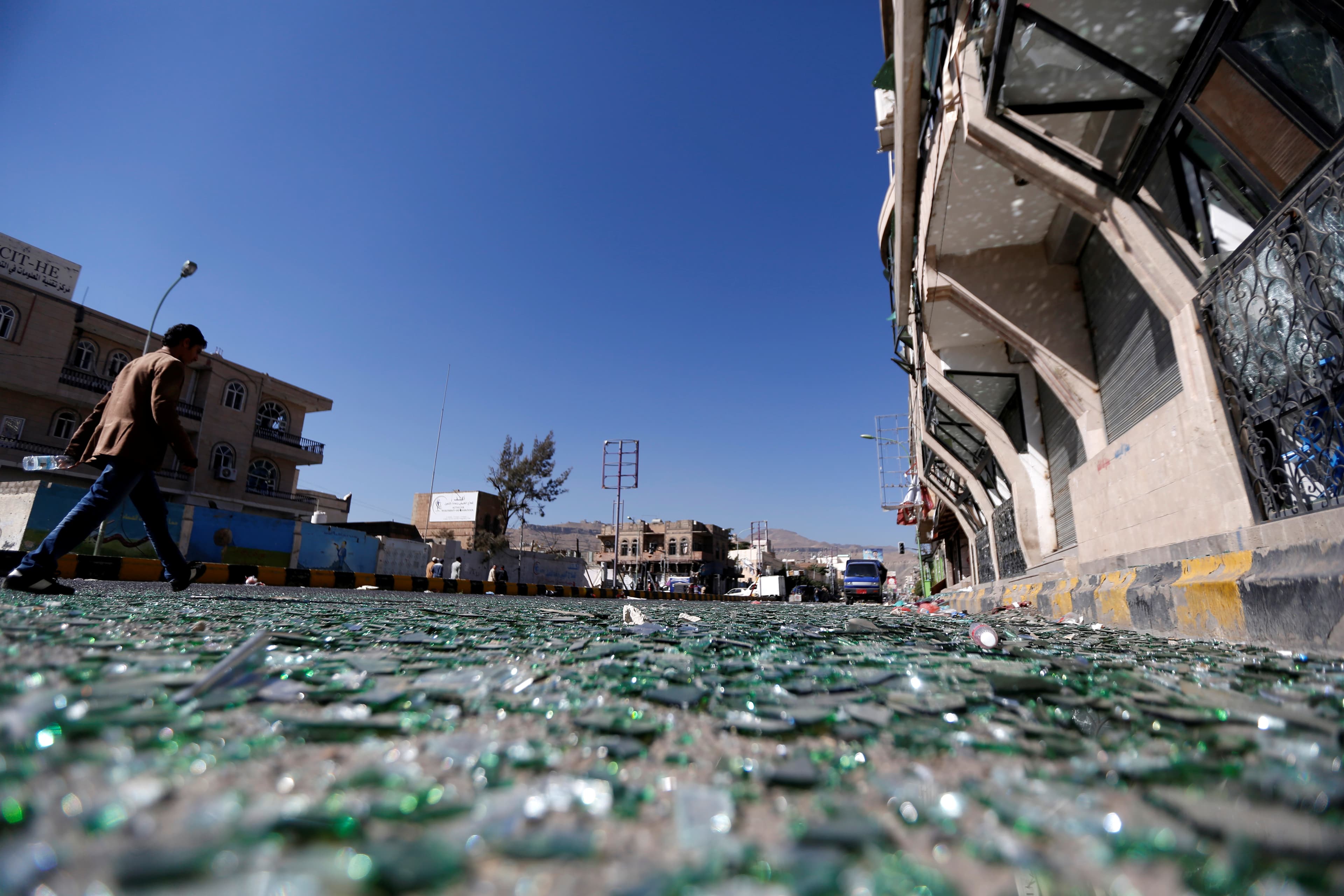 A man walks on a street where Houthis have recently clashed with forces loyal to Yemen's former president