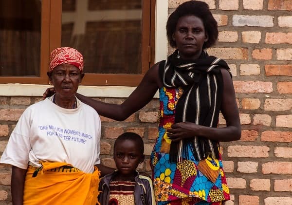 Genocide widows sit in the courtyard of Impinganzima care home, waiting for friends and family to visit.