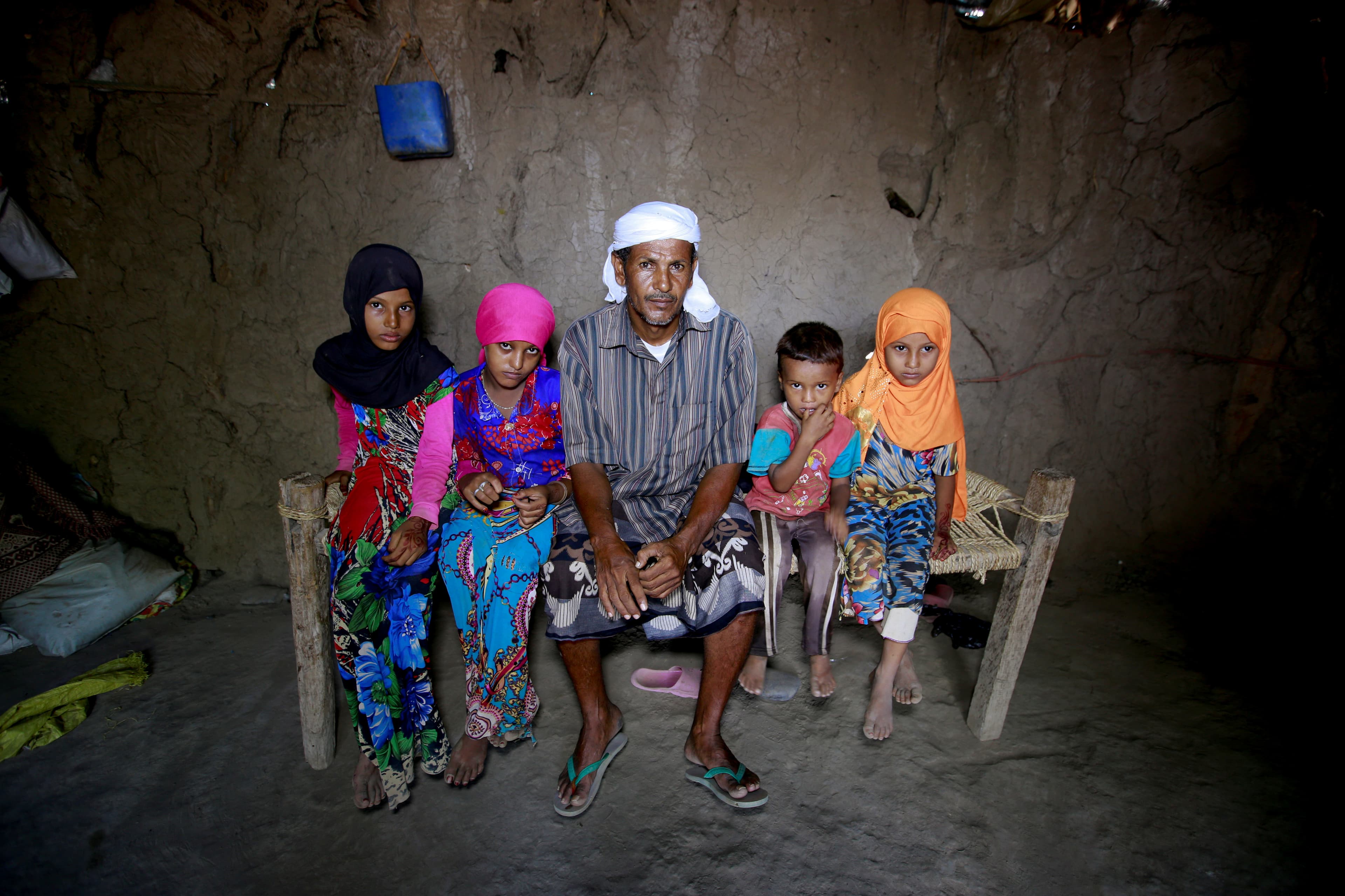 Saida Ahmed Baghili, second from left, 19, who is recovering from severe malnutrition, poses for a photograph with her father and her sisters Jalila, left, 12, and Amal, right, 7, and 4-year-old brother Omar at their hut in al-Tuhaita district of Hodeidah