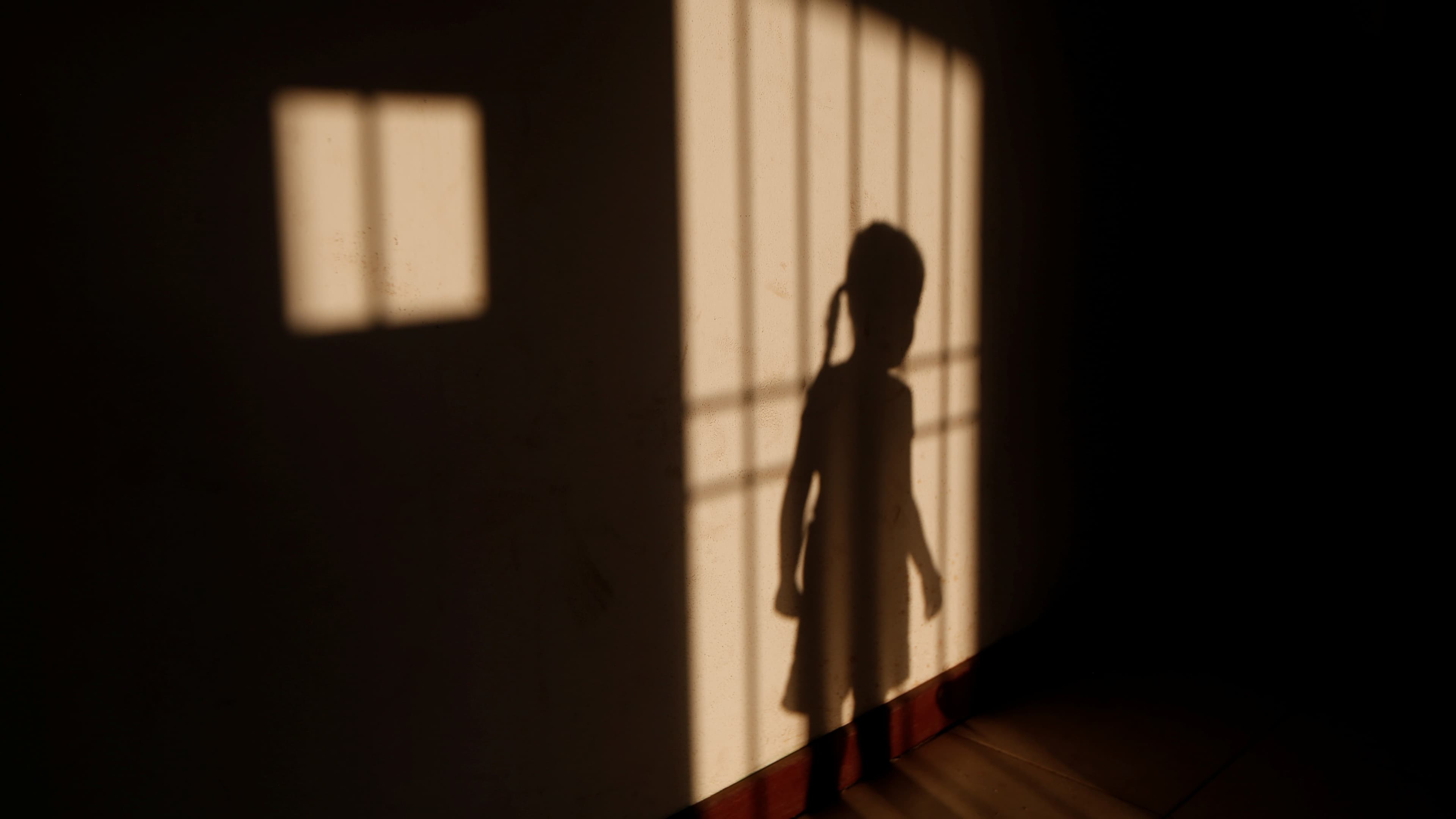 a girl's shadlow on a wall in venezuela