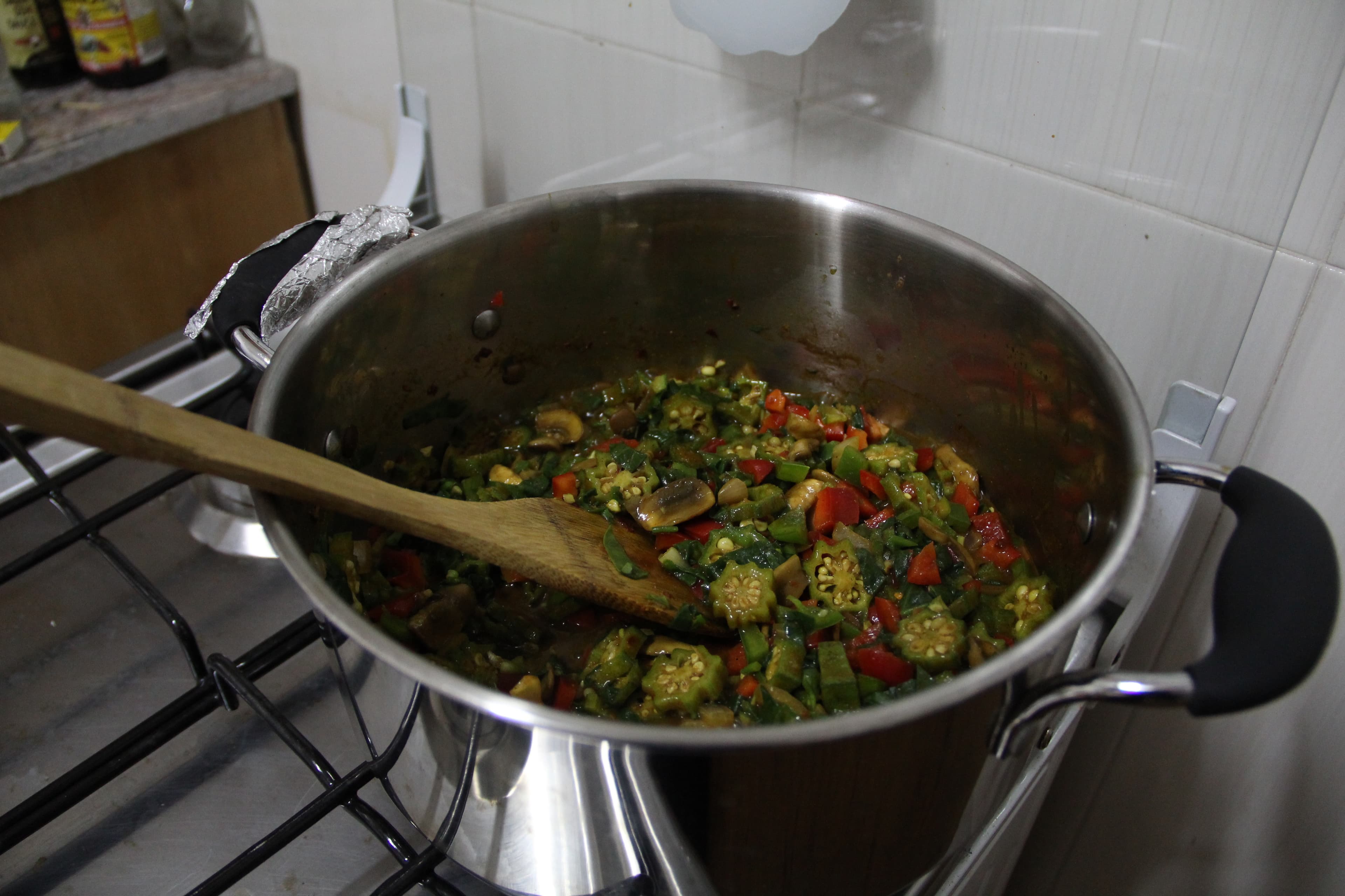 Okra soup colorful greens and yellows in a pot.