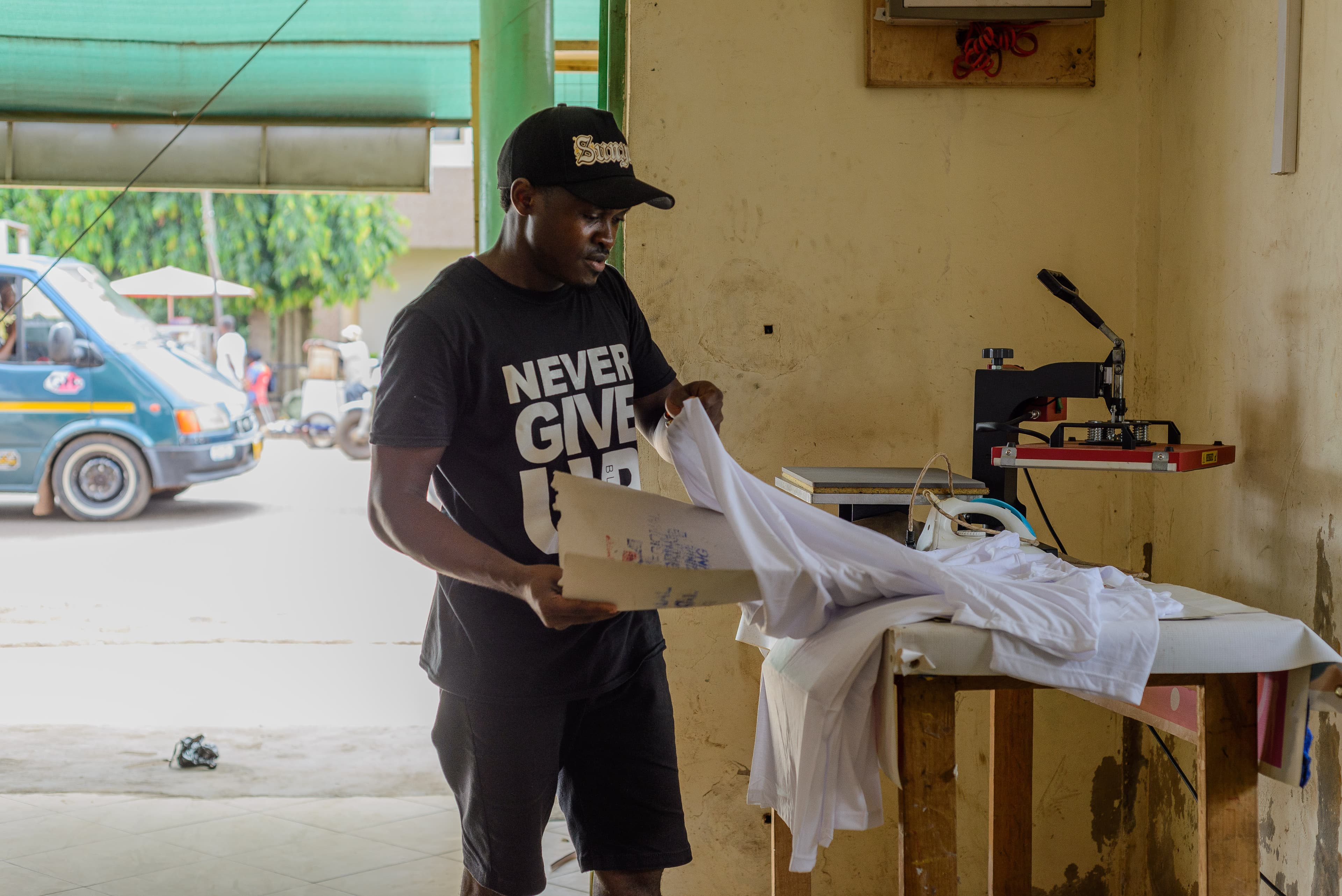 A young man works on a screen print design