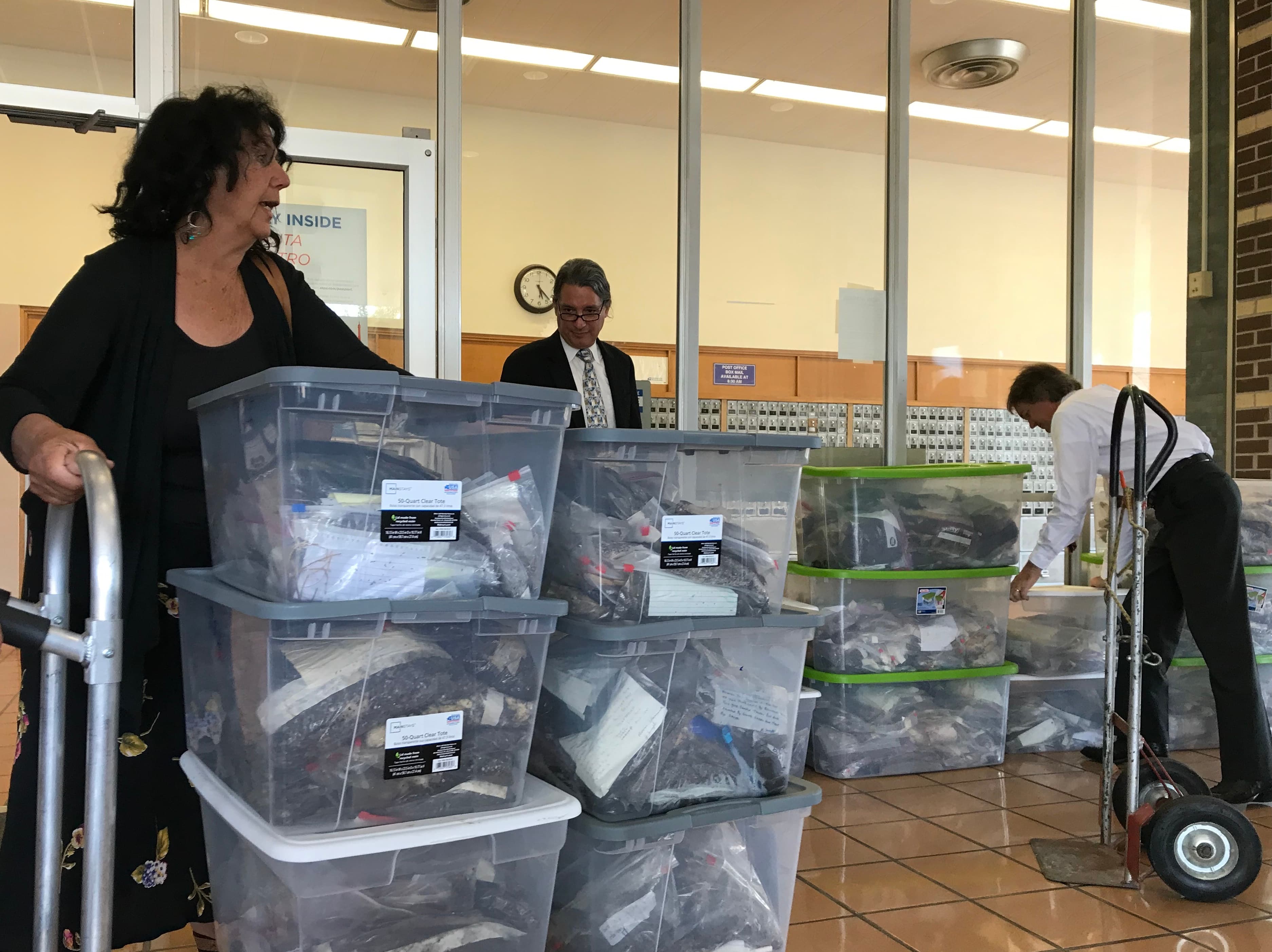 A woman pushed large containers of plastic pellets through a courtroom.