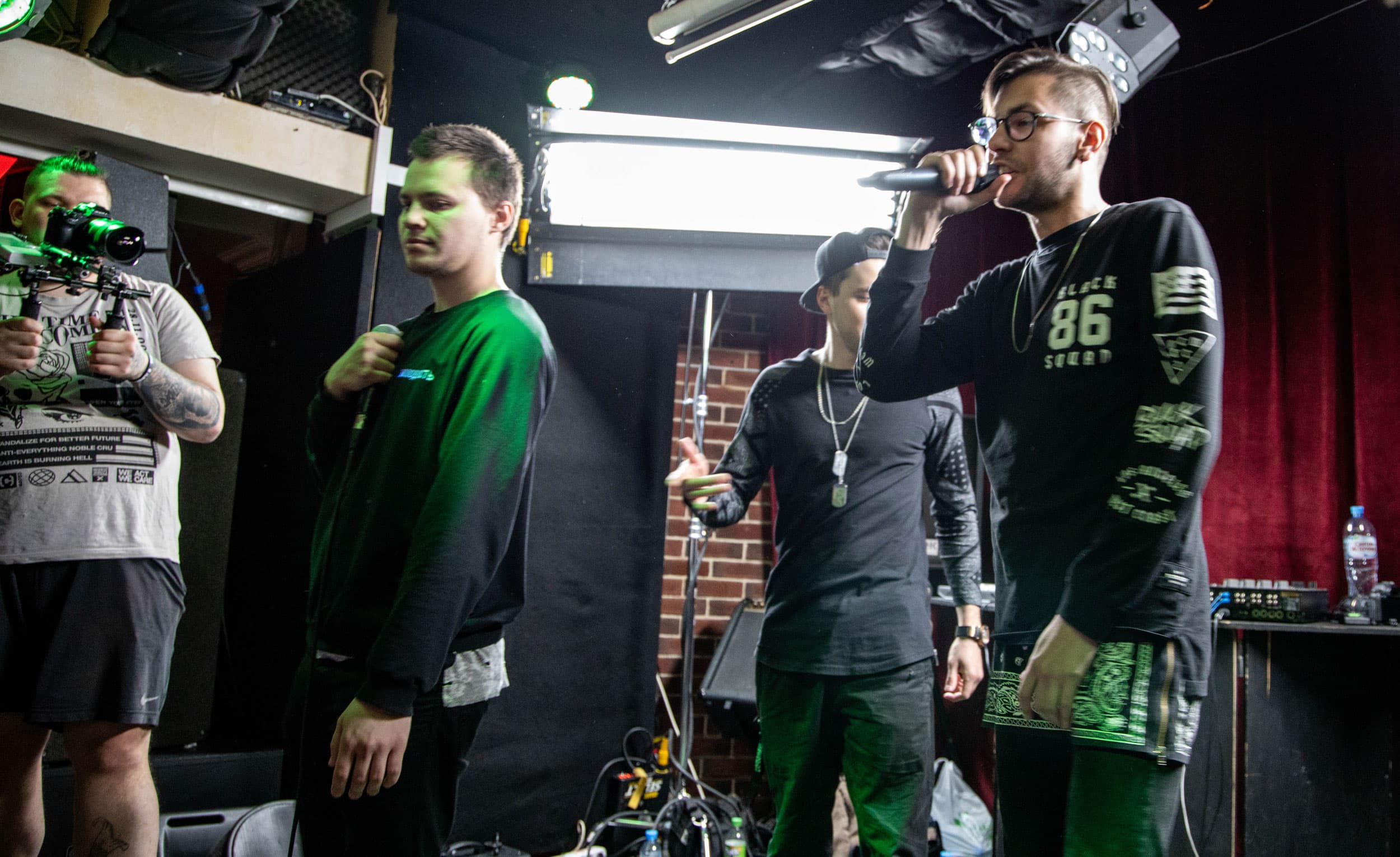 A man raps on a stage.