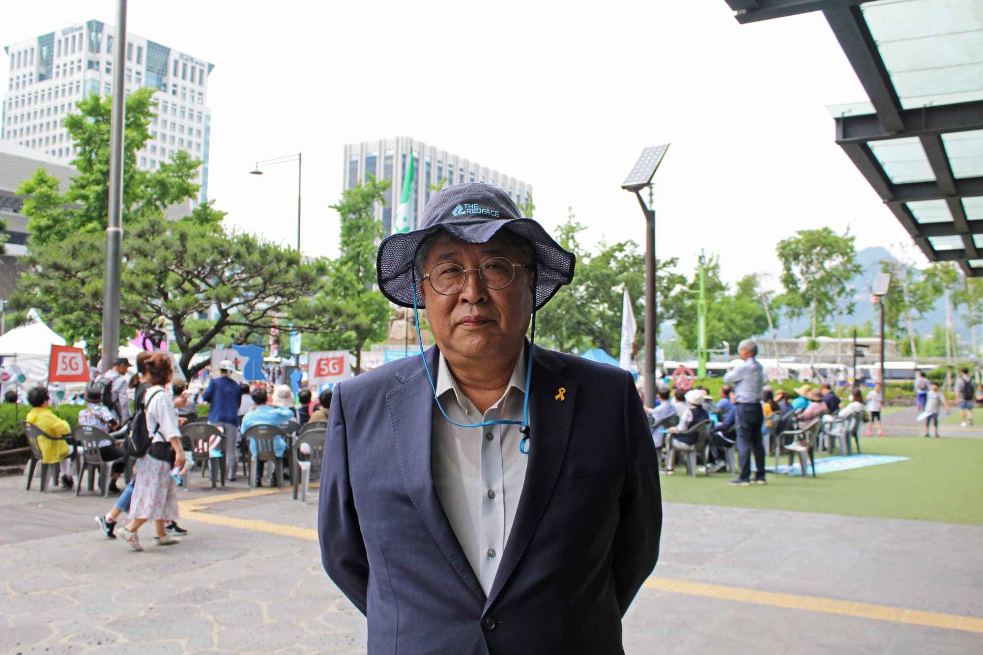 A man wears a suit at a protest in Seoul