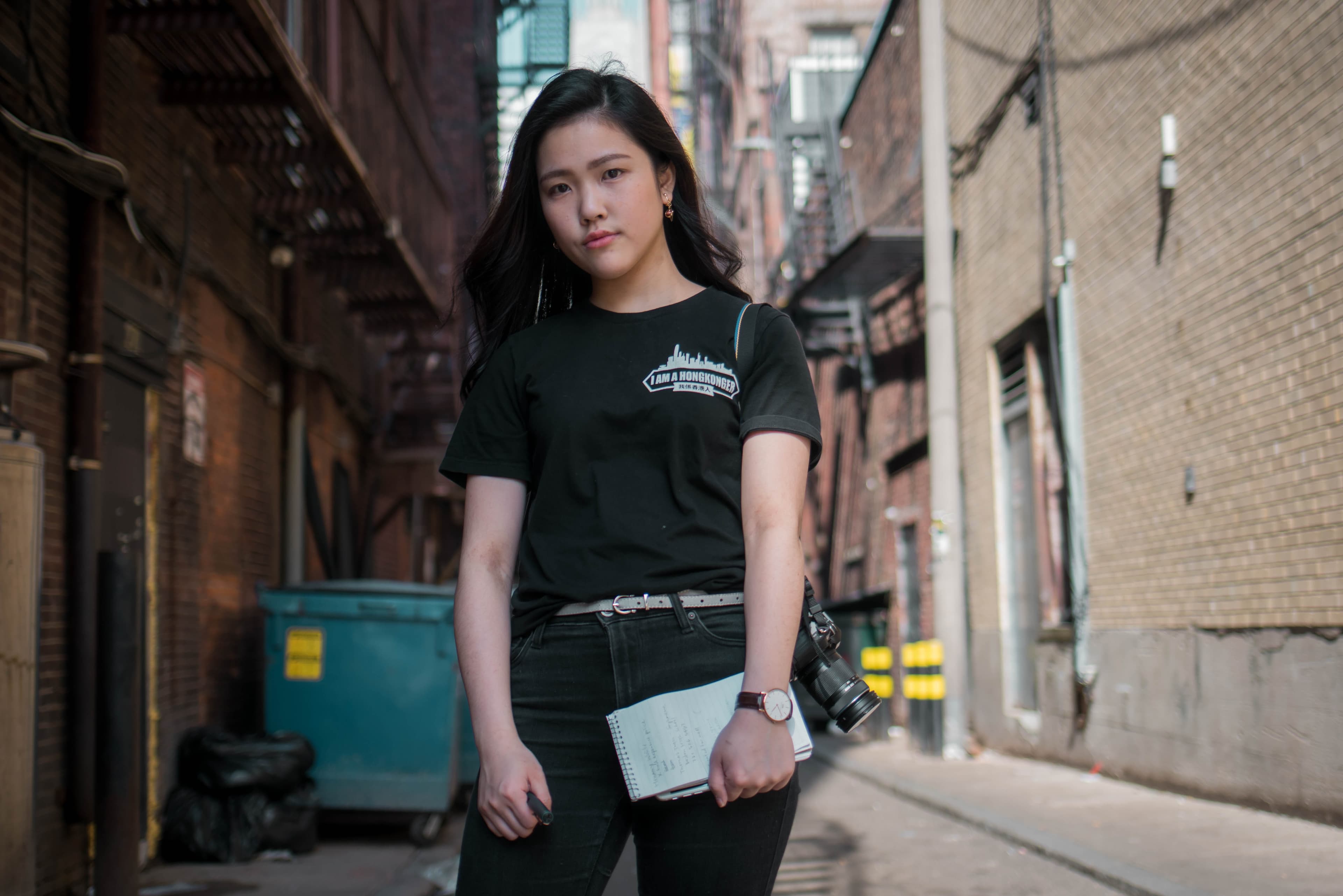 A young woman with a camera and notepad