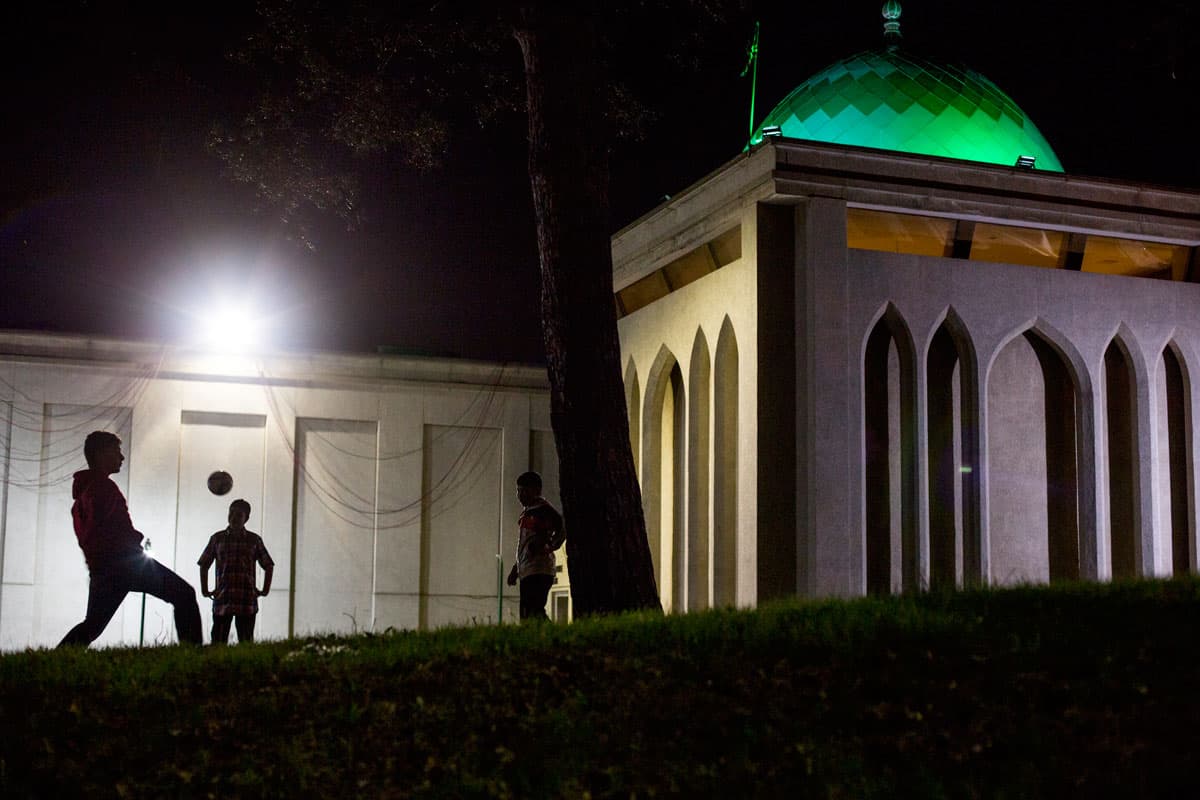 A group of Iranian children playing soccer outside the Iranian grand mosque in Toronto.