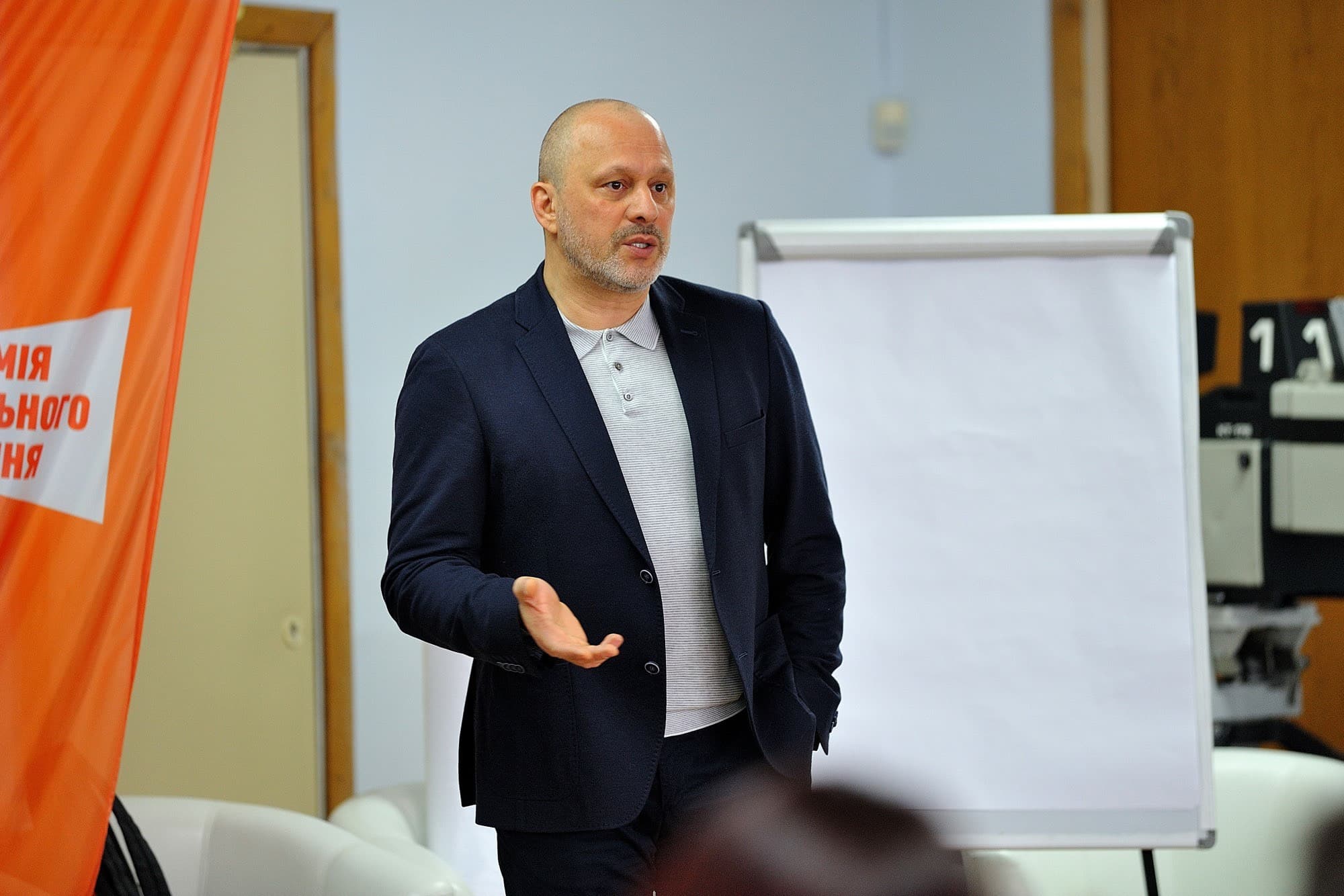 Photo of man in blue suit leading a presentation