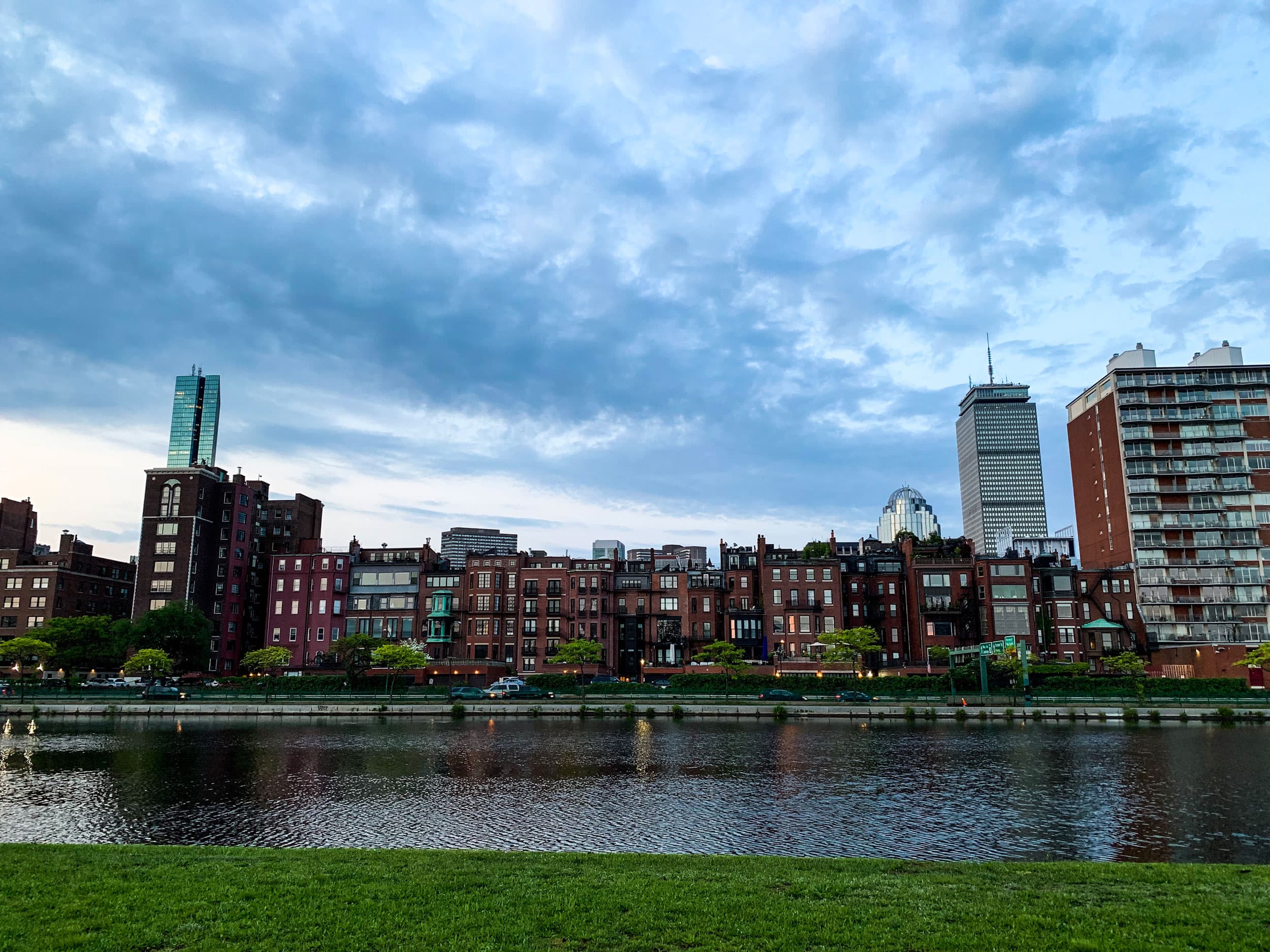 A row of rowhouses sit alongside the Charles River
