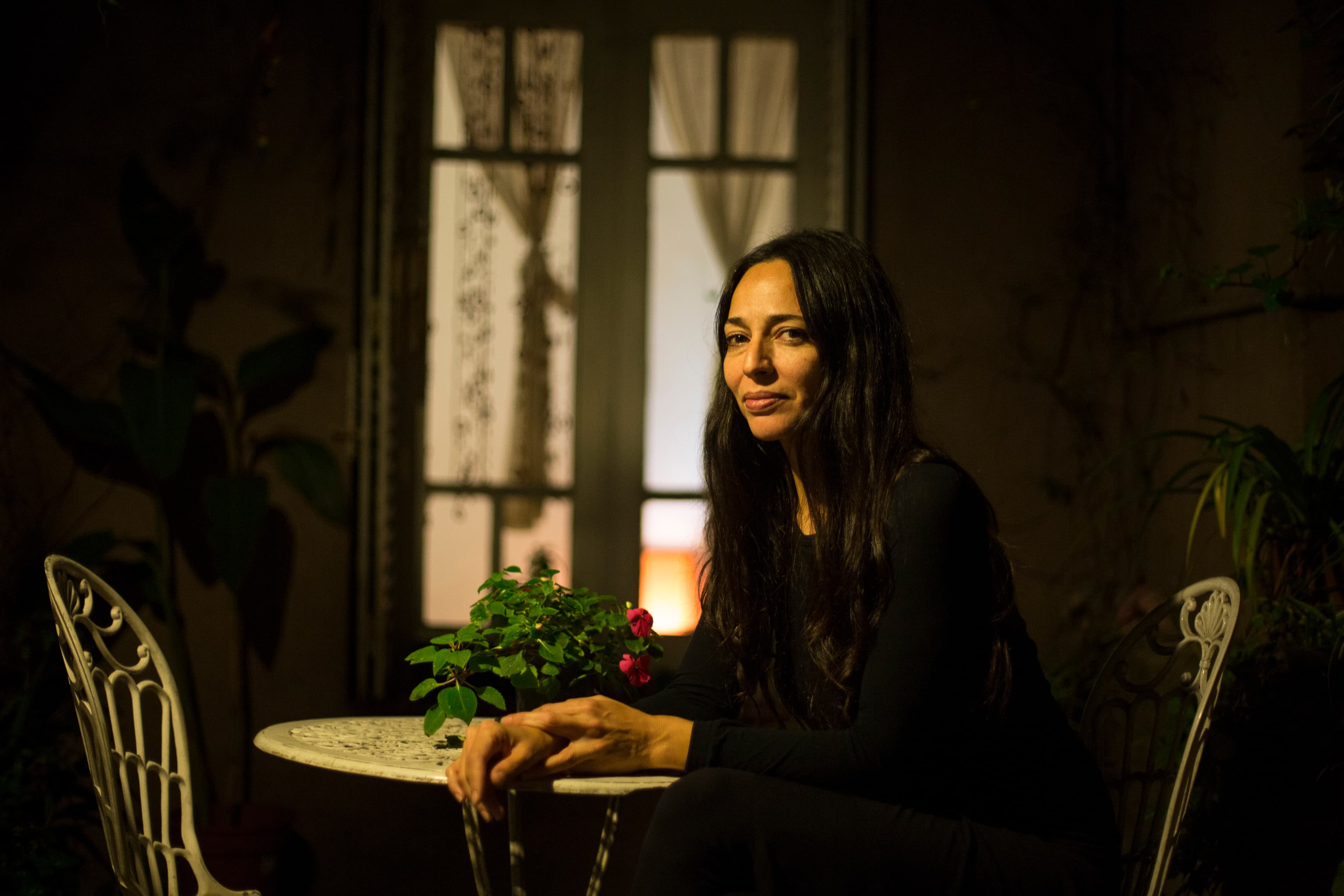 A woman sits at a table.