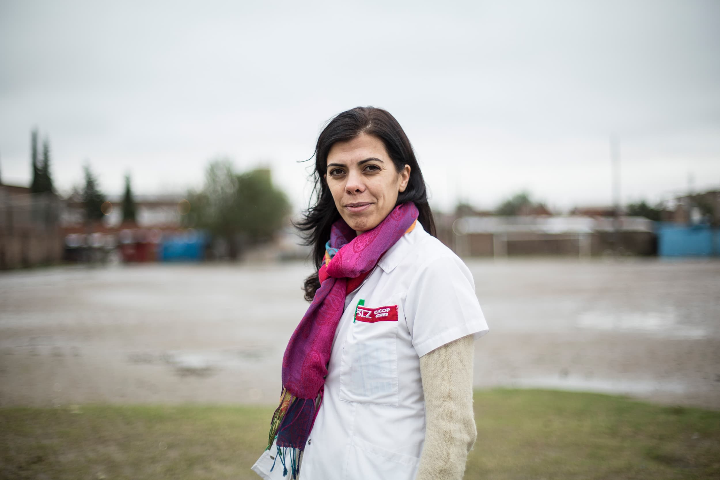 A portrait of a women standing outside.