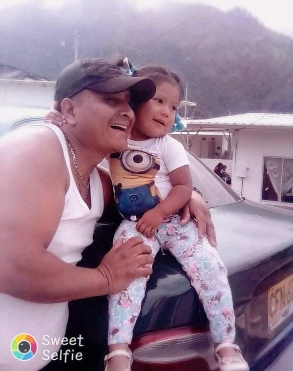 A man poses with a small child