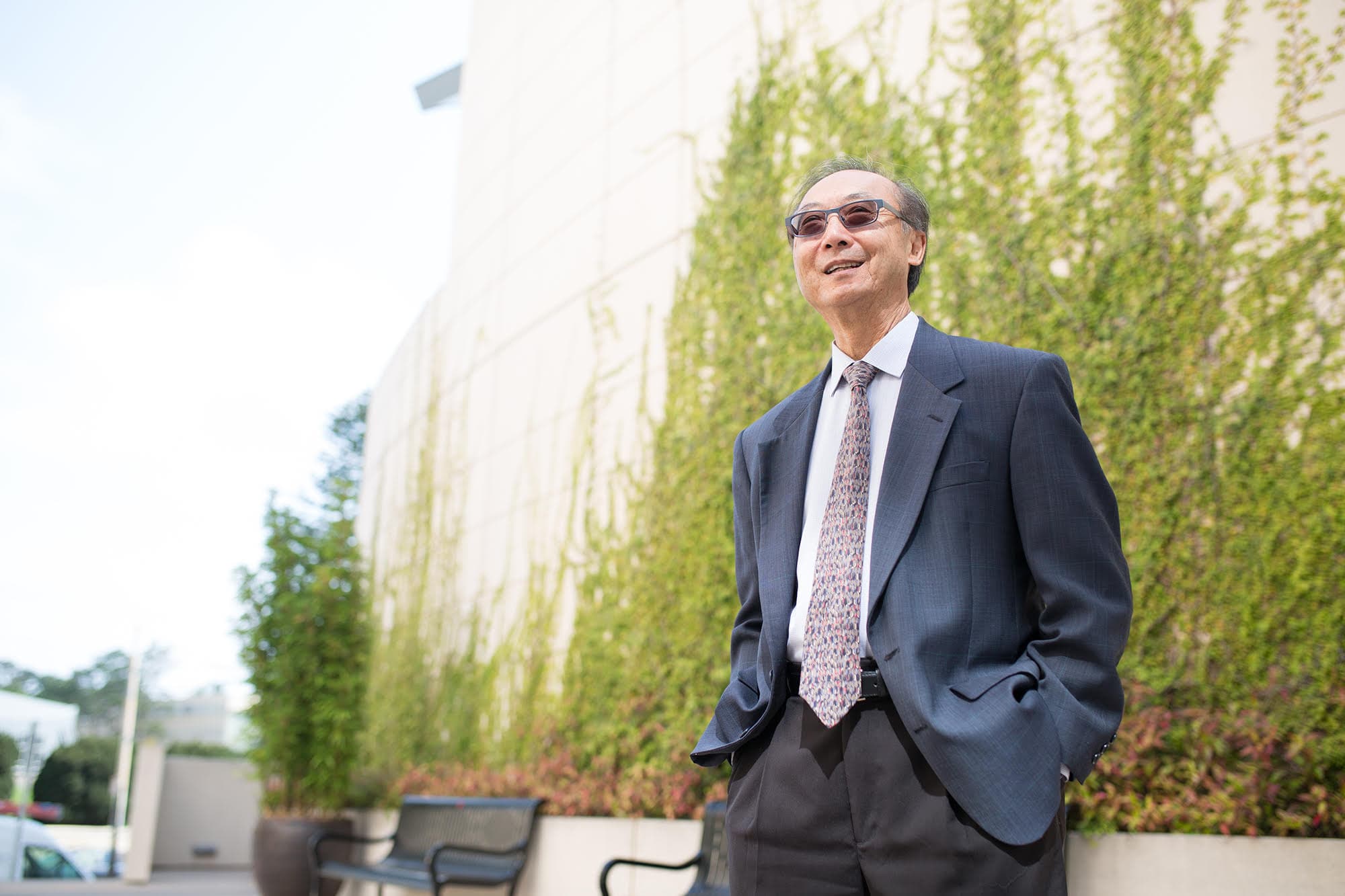 A man stands, smiling.