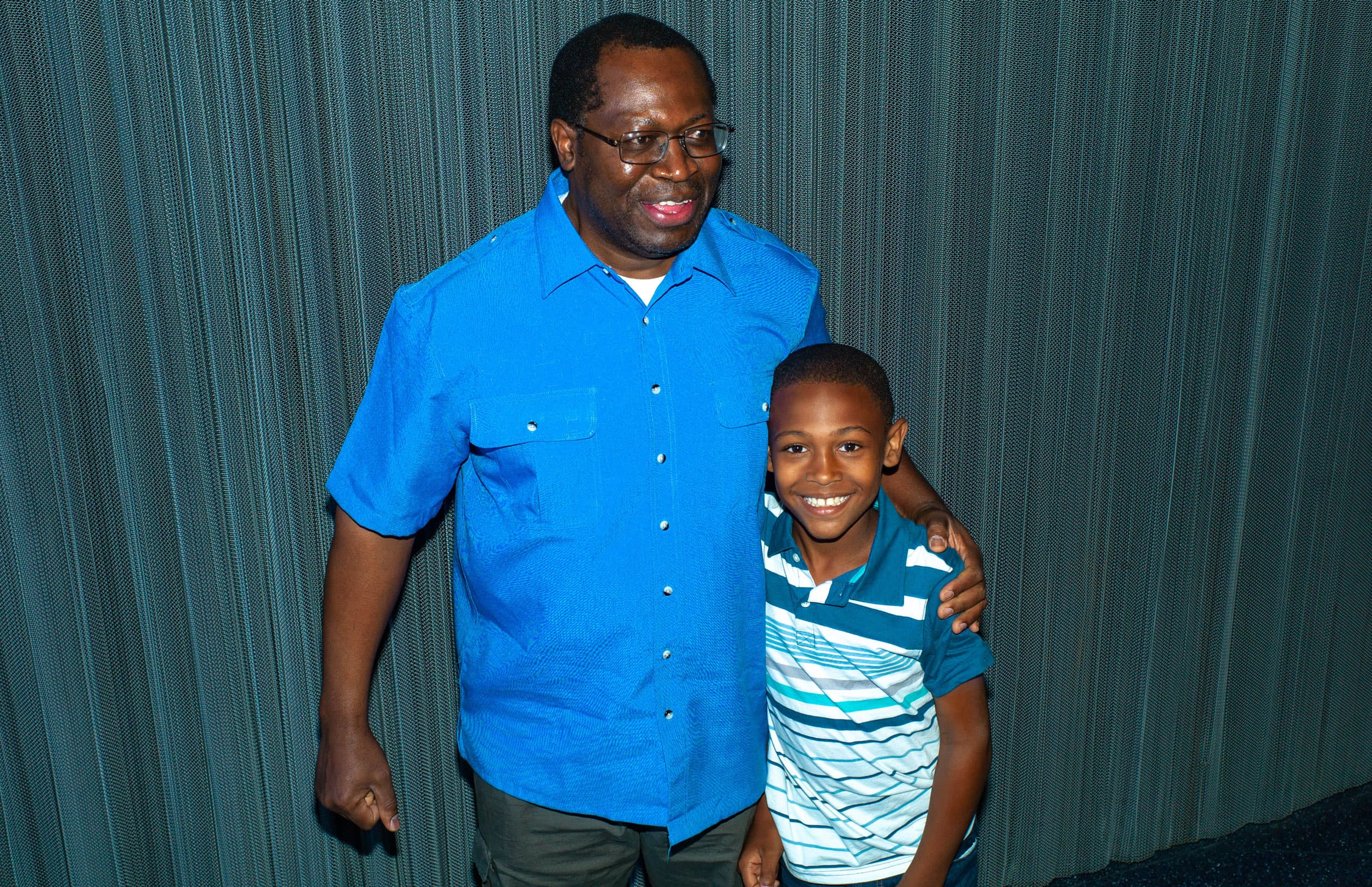 A group of four people smile in a posed photo