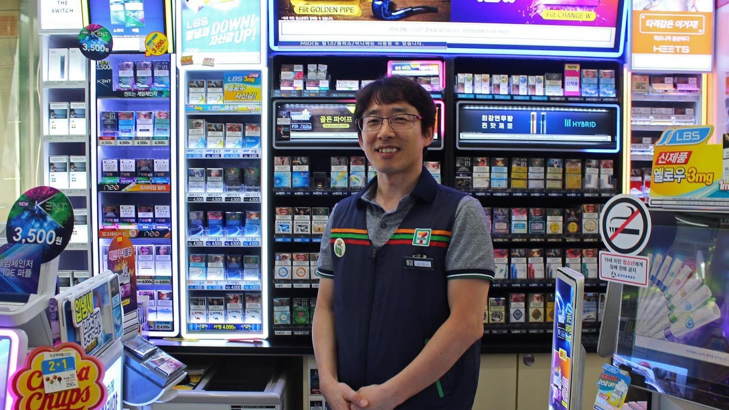 Man stands in 7-Eleven in work vest
