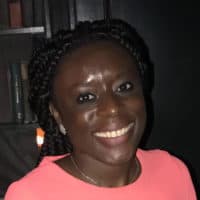 A woman smiling at a camera.