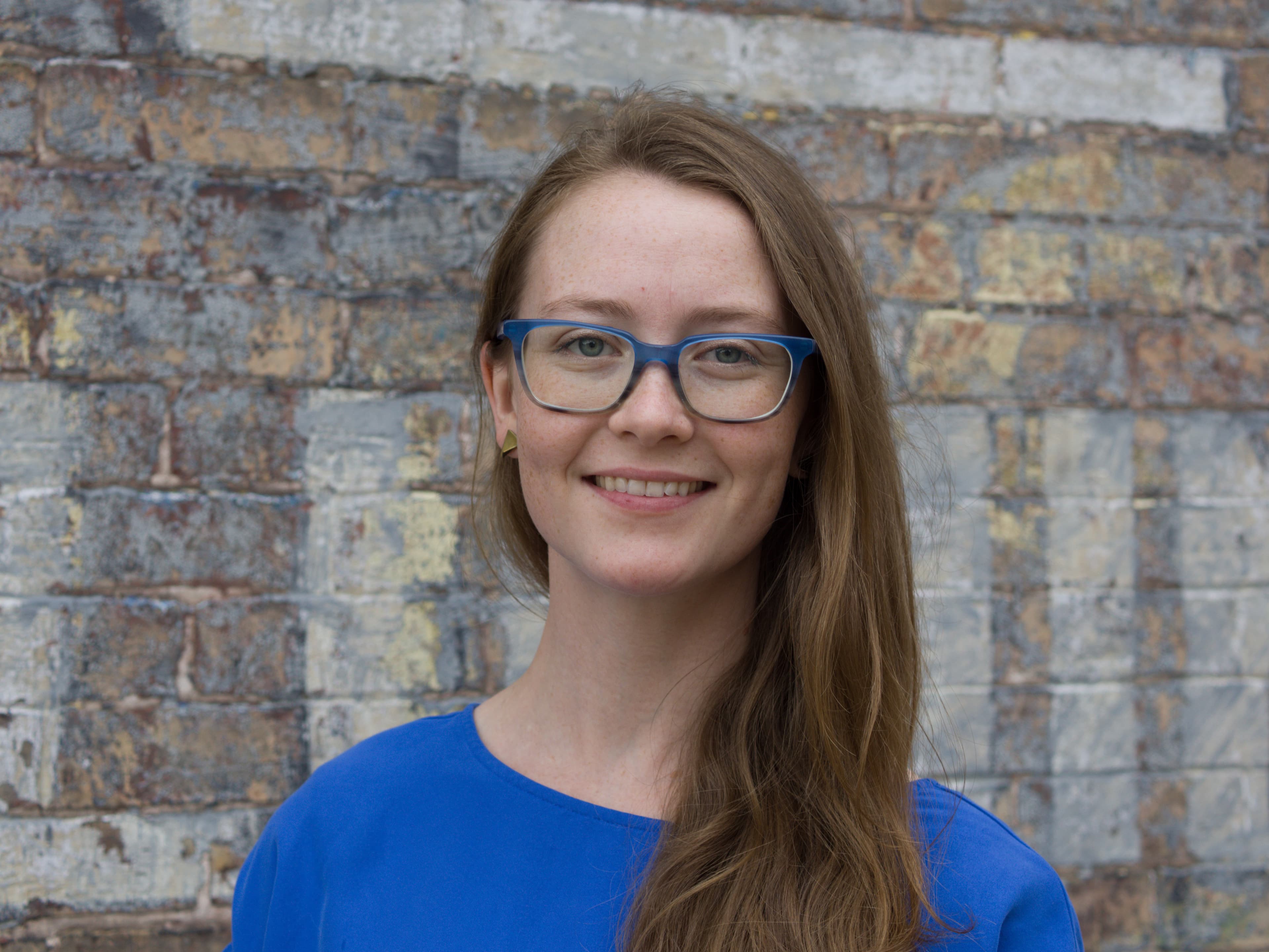Woman in a blue dress and glasses