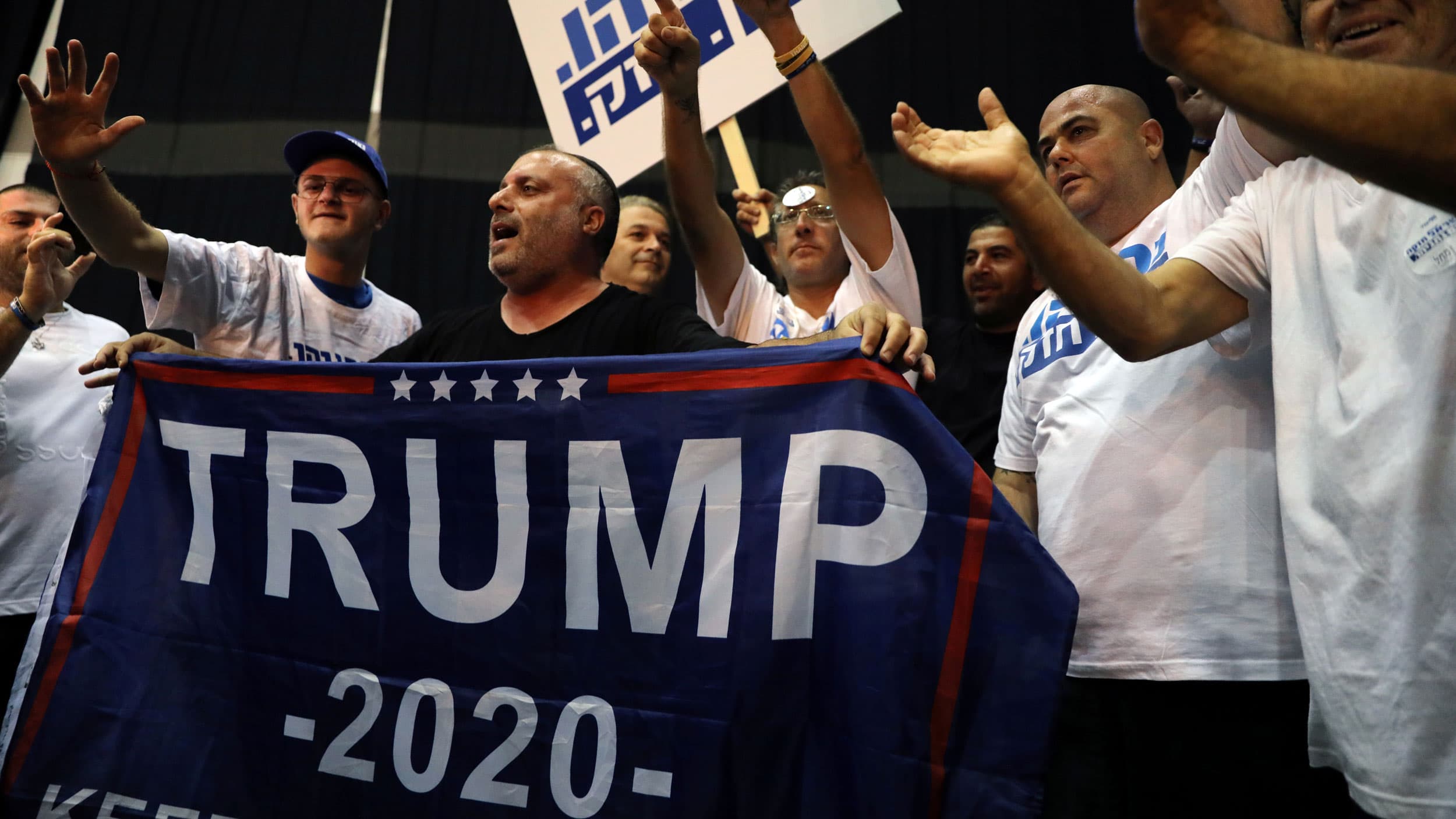 Supporters of Israeli Prime Minister Benjamin Netanyahu's Likud party react to exit polls in Israel's parliamentary election at the party headquarters in Tel Aviv, Israel, on Sept. 17, 2019.  One sign says "Trump 2020" as well.