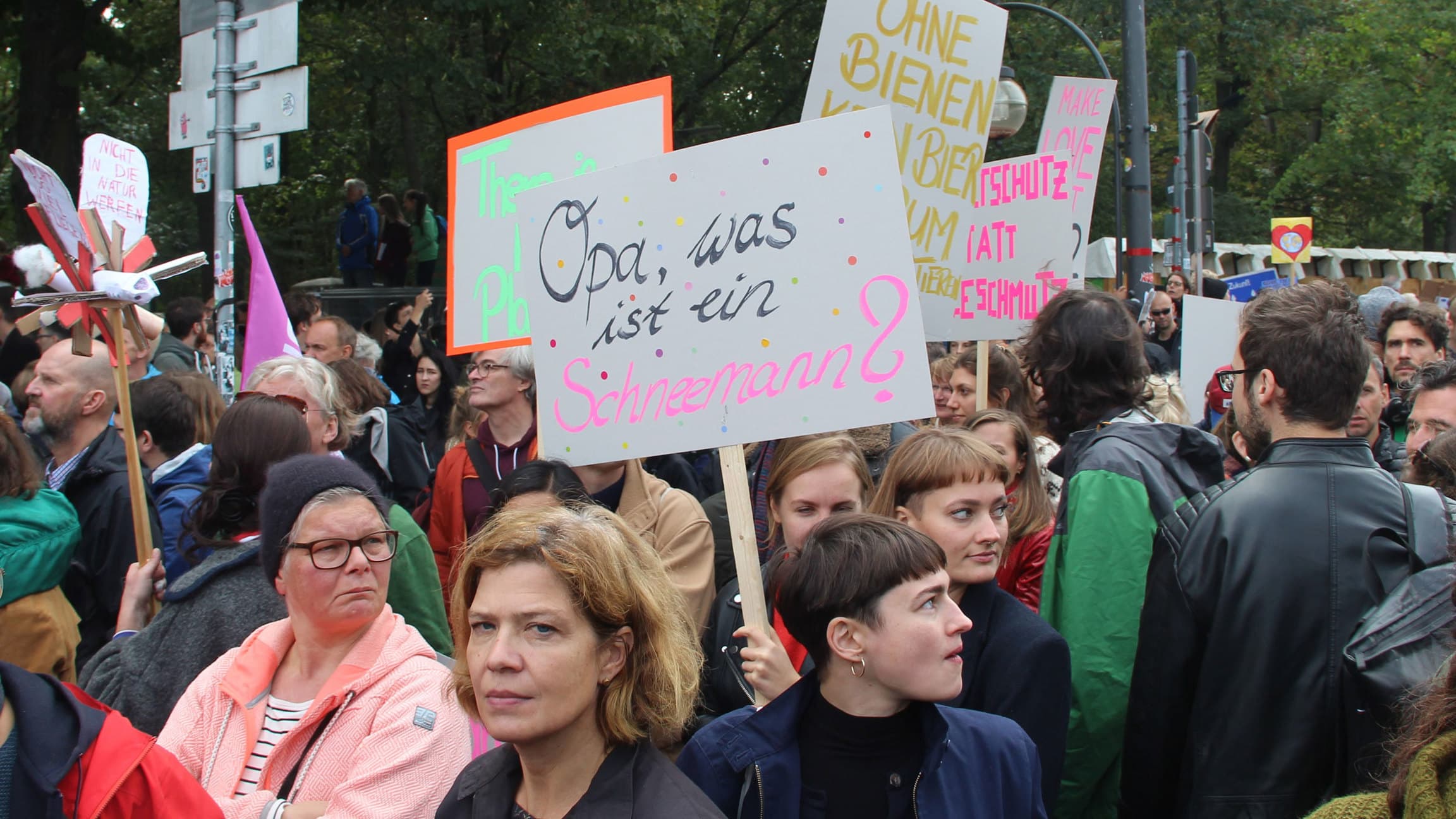 A protester holds a sign reading, 