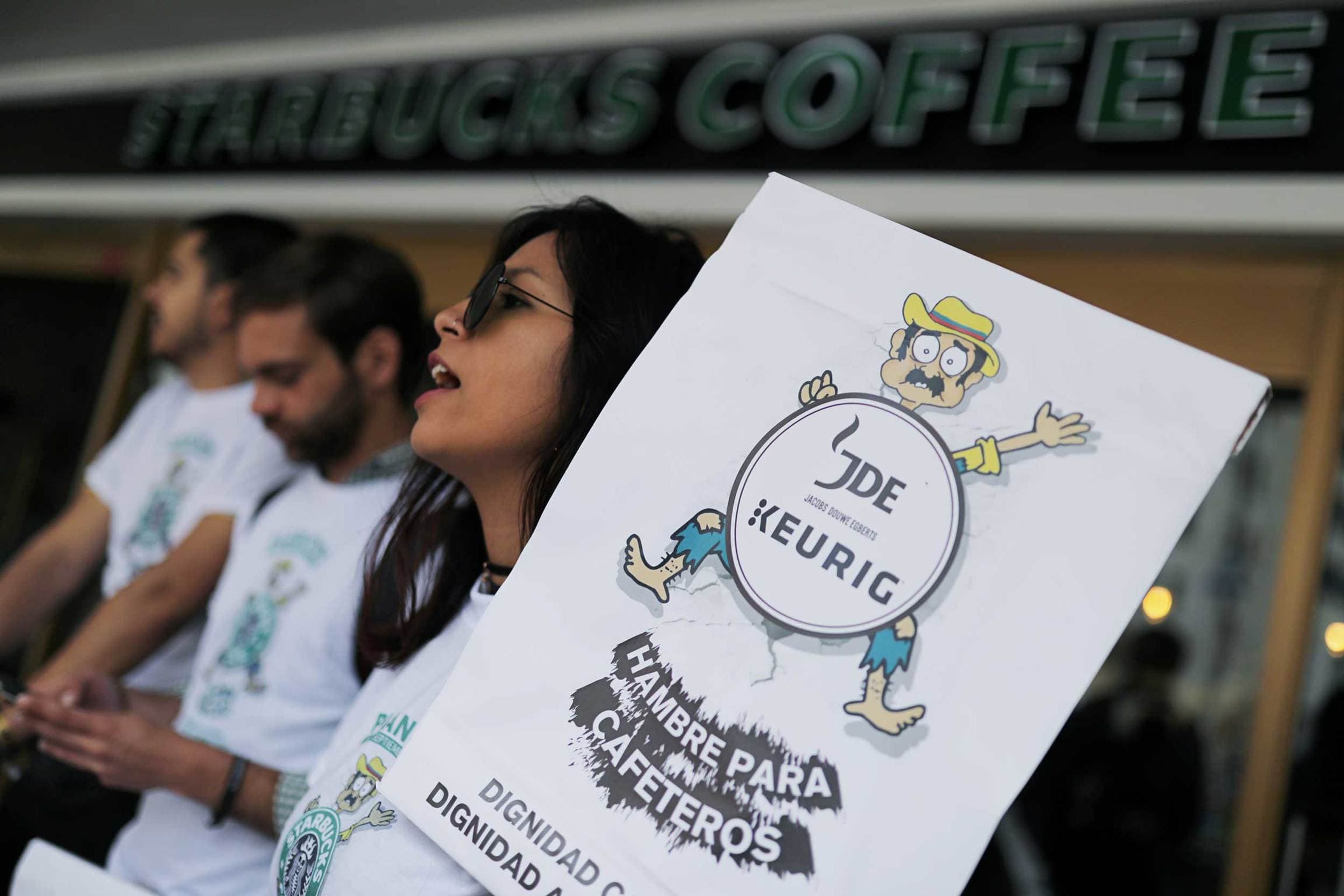 A protester holds a sign in Spanish that reads 