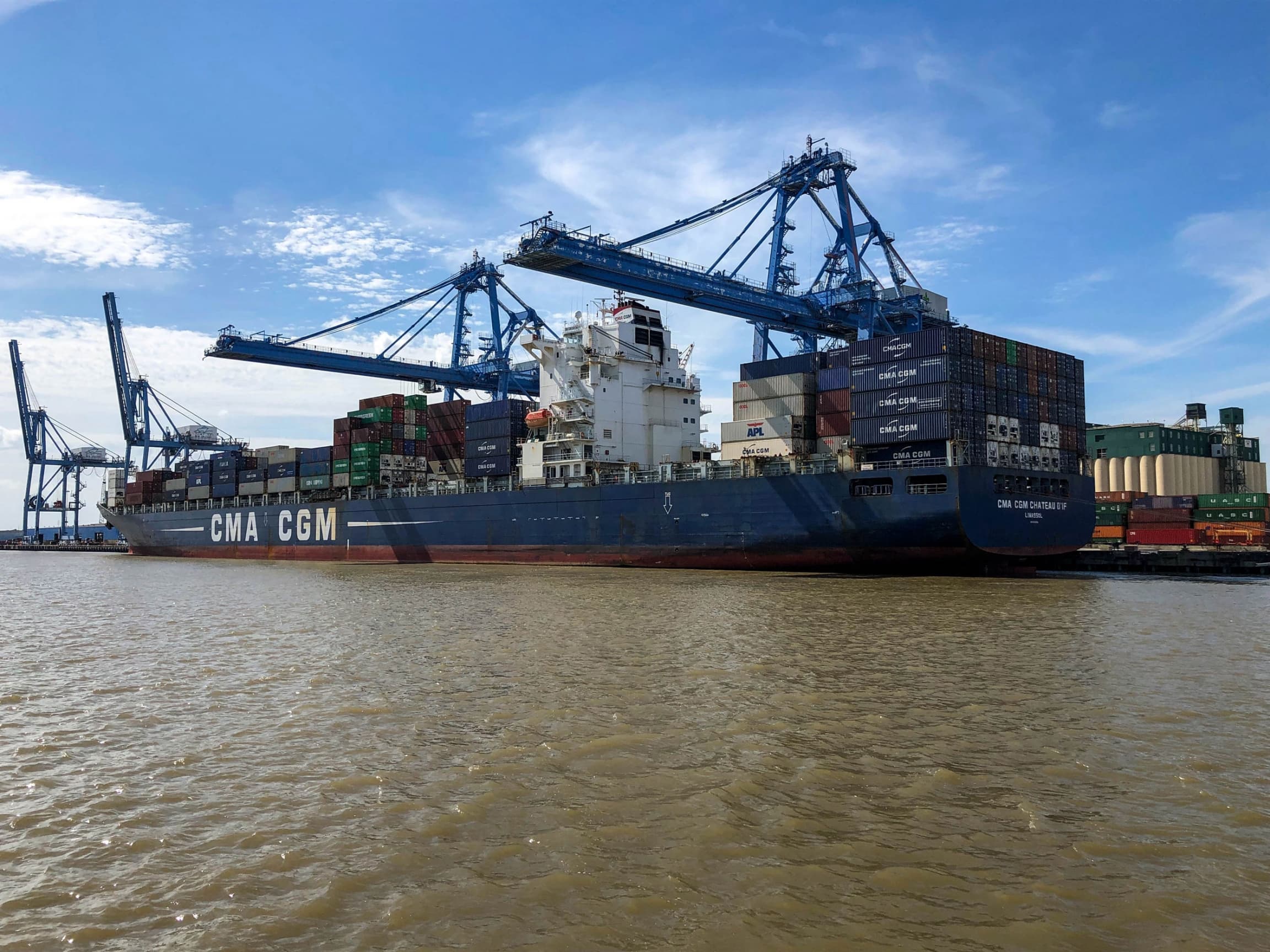 A large ship is shown carrying many containers of goods.
