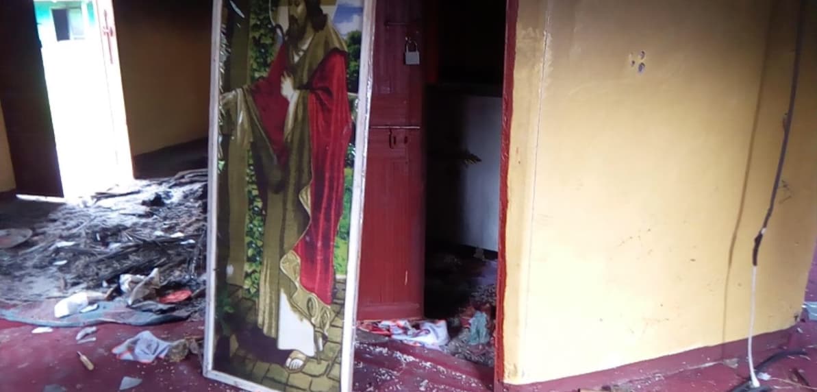 A broken religious relic inside a destroyed church