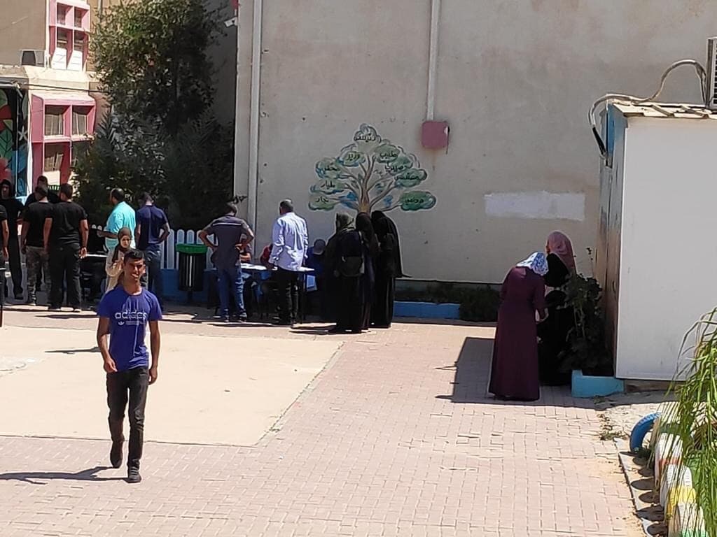 A group gathers at a gas station in the Negev