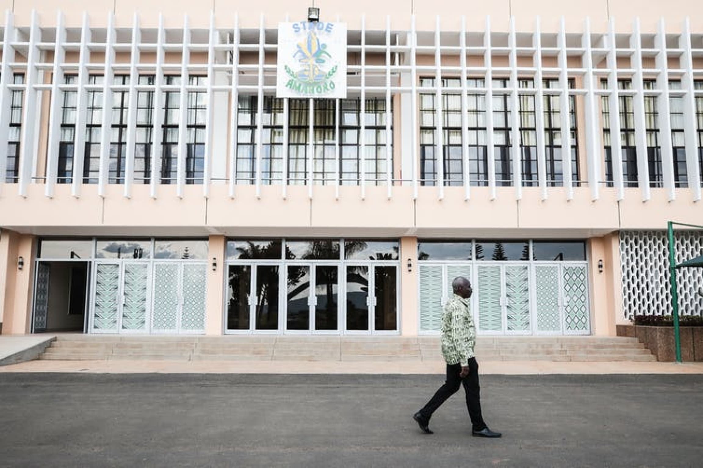 A man walks in front of a building.