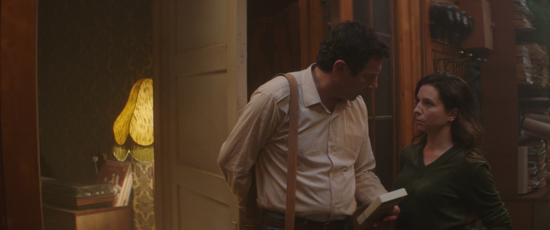 A man and a woman stand by a door