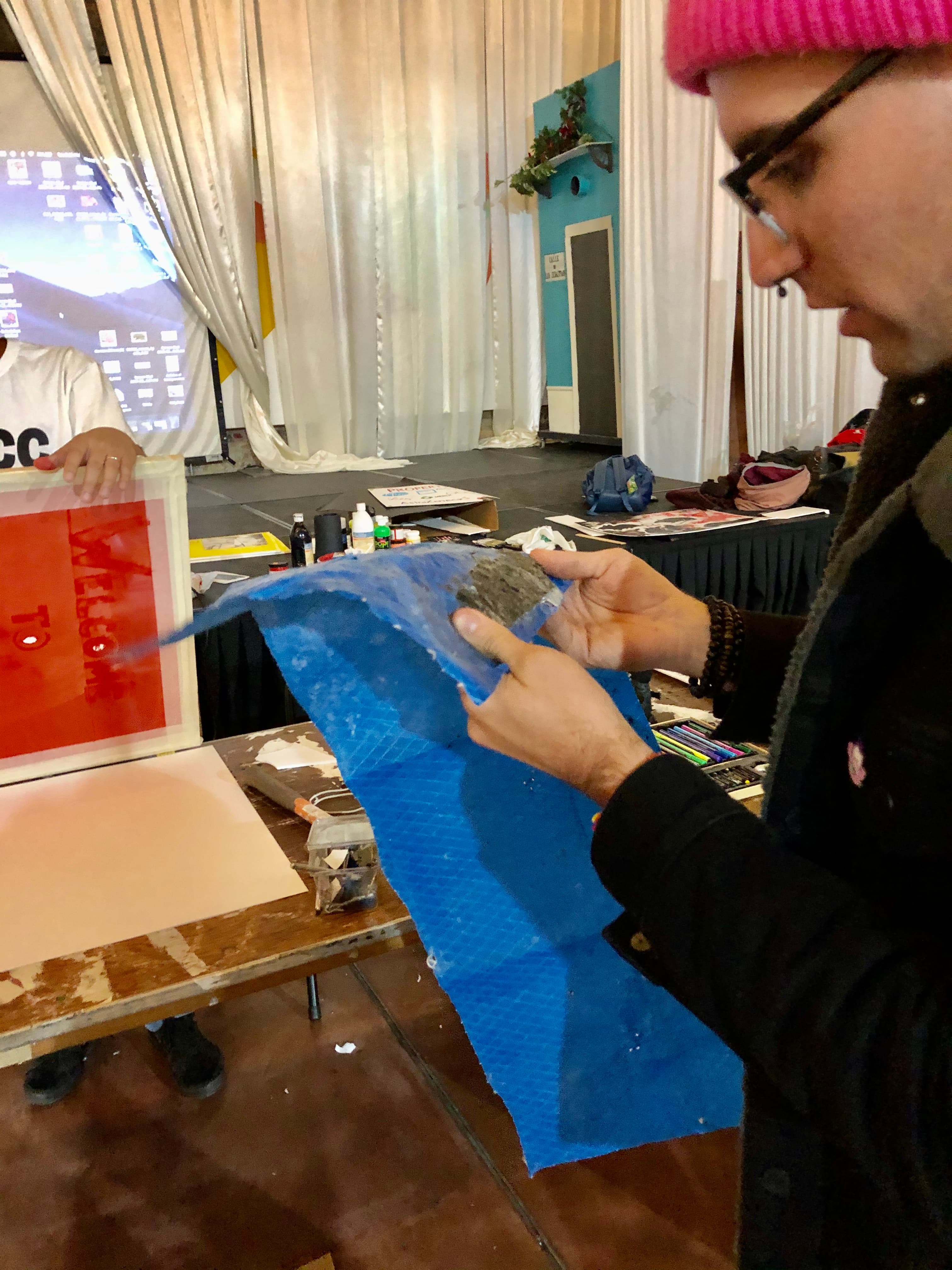 Ephran Ramirez Jr. with a piece of the blue FEMA tarp that covered his father’s neighbor's house in San Sebastián, Puerto Rico after Hurricane Maria.