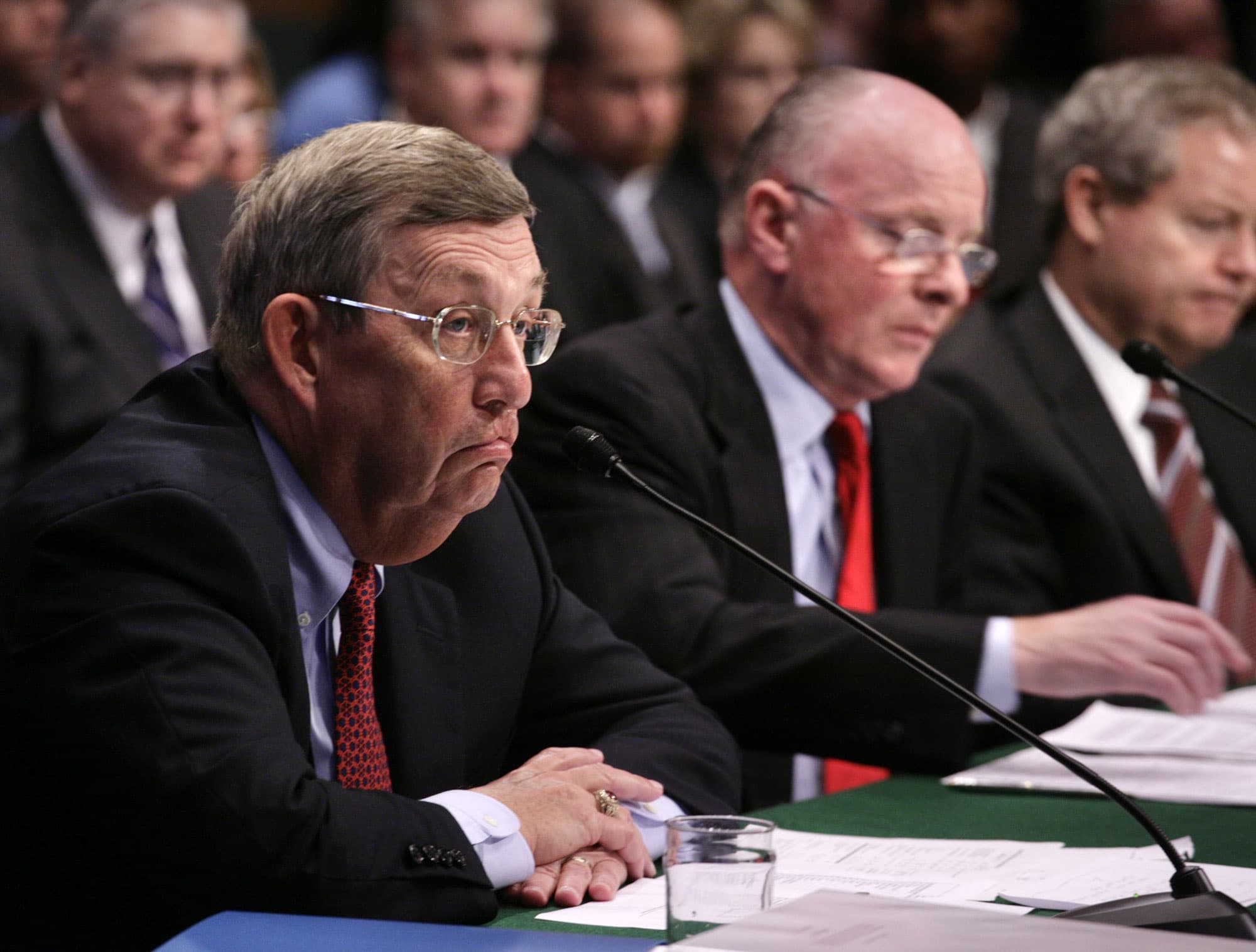 A man hunches over a panel table.