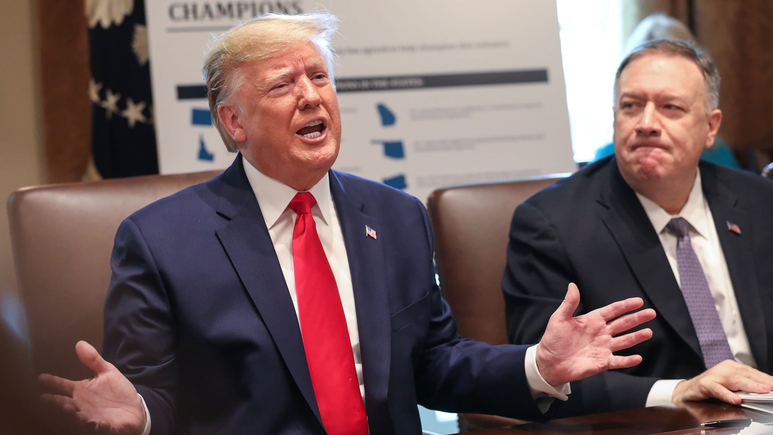 President Trump sits next to Mike Pompeo