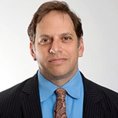 A professional headshot of a man