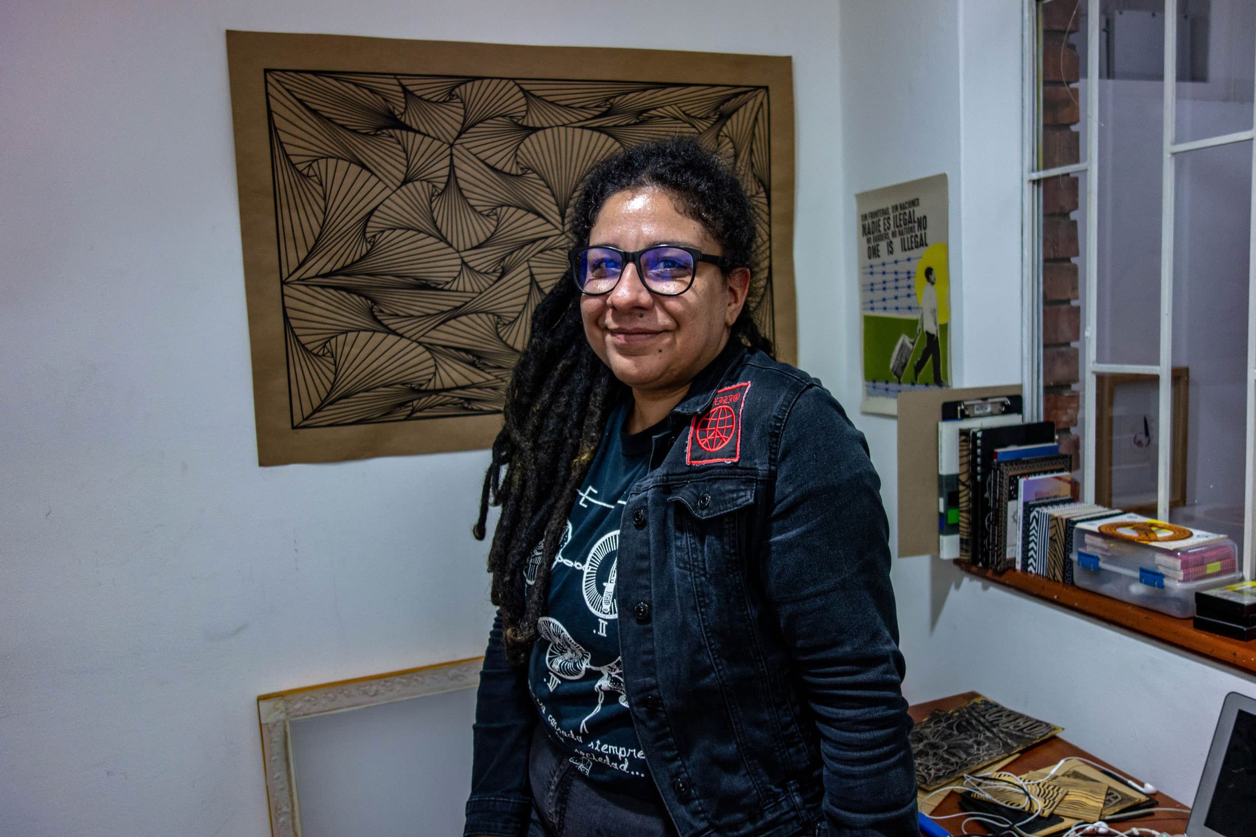 Exilio singer Susana González is shown wearing dread locks and glasses.