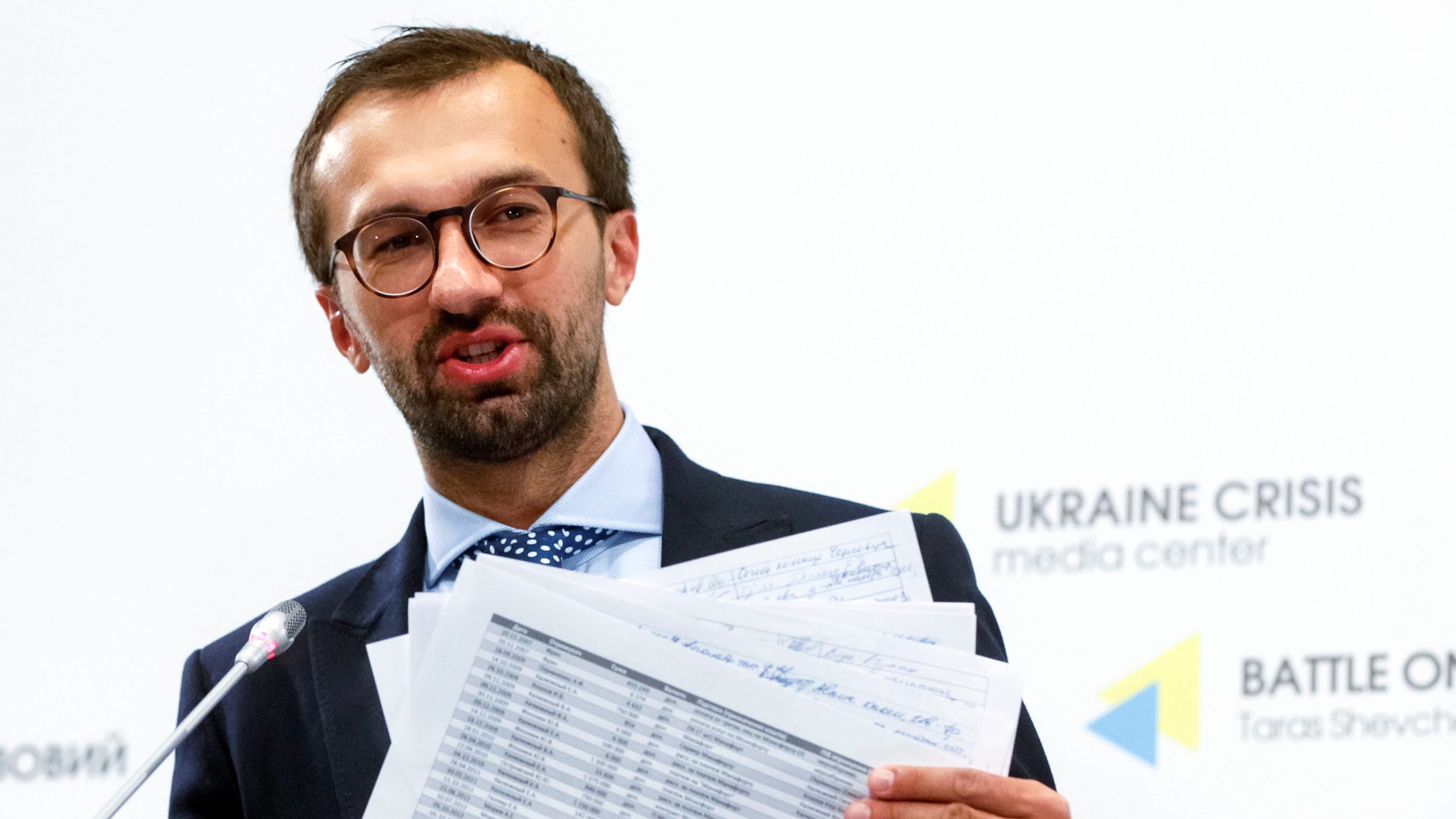 Former Ukrainian lawmaker Sergii Leshchenko displays papers from secret ledgers