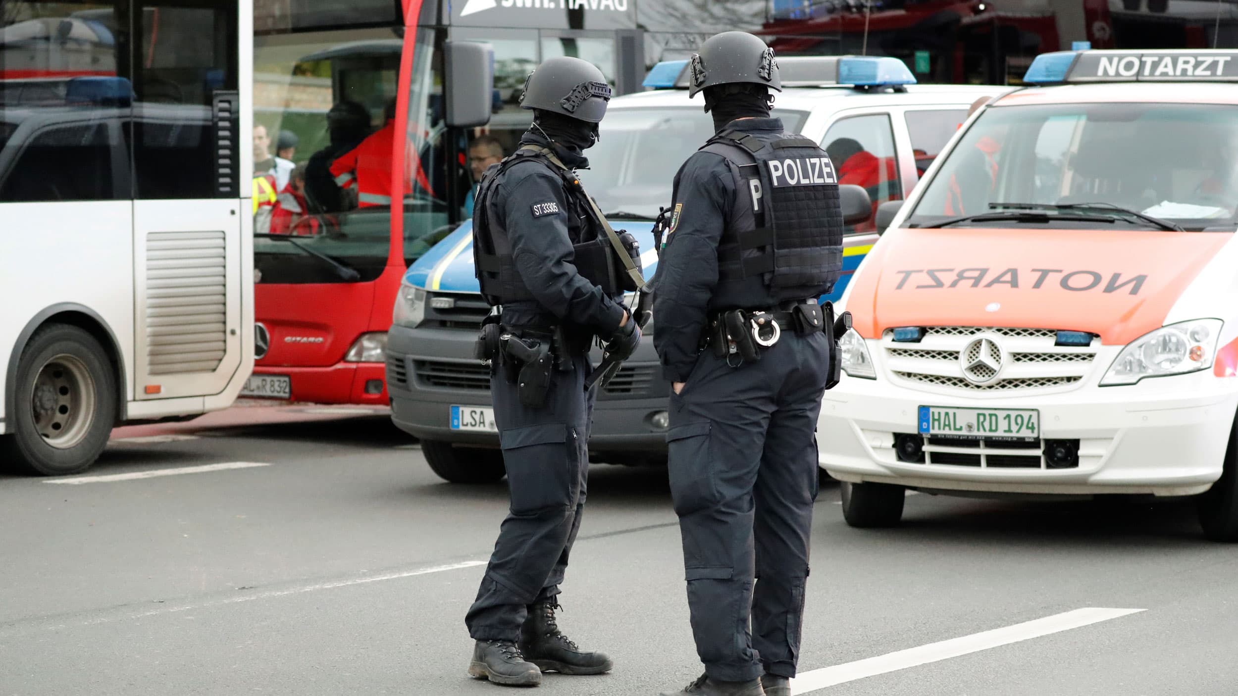 Police officers stand guard near the site of a shooting
