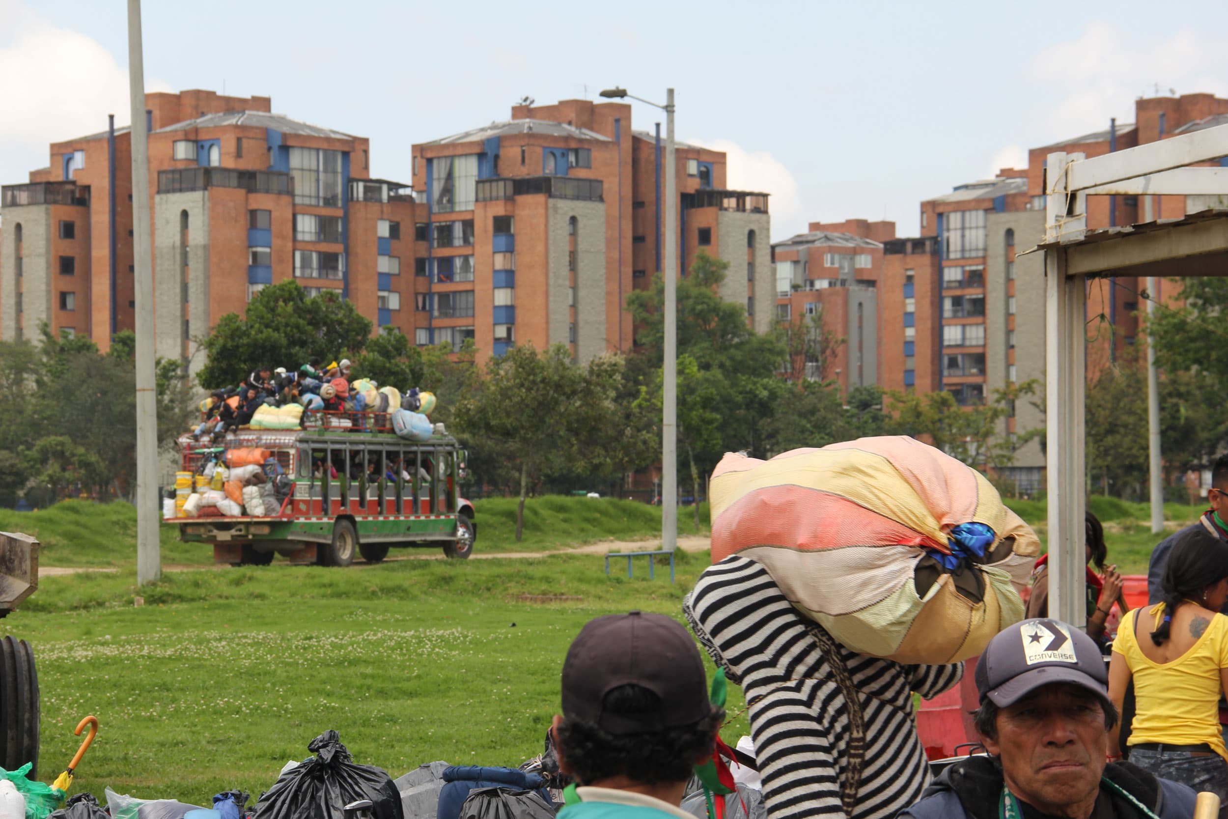 A colorful bus is shown in the distance driving away.
